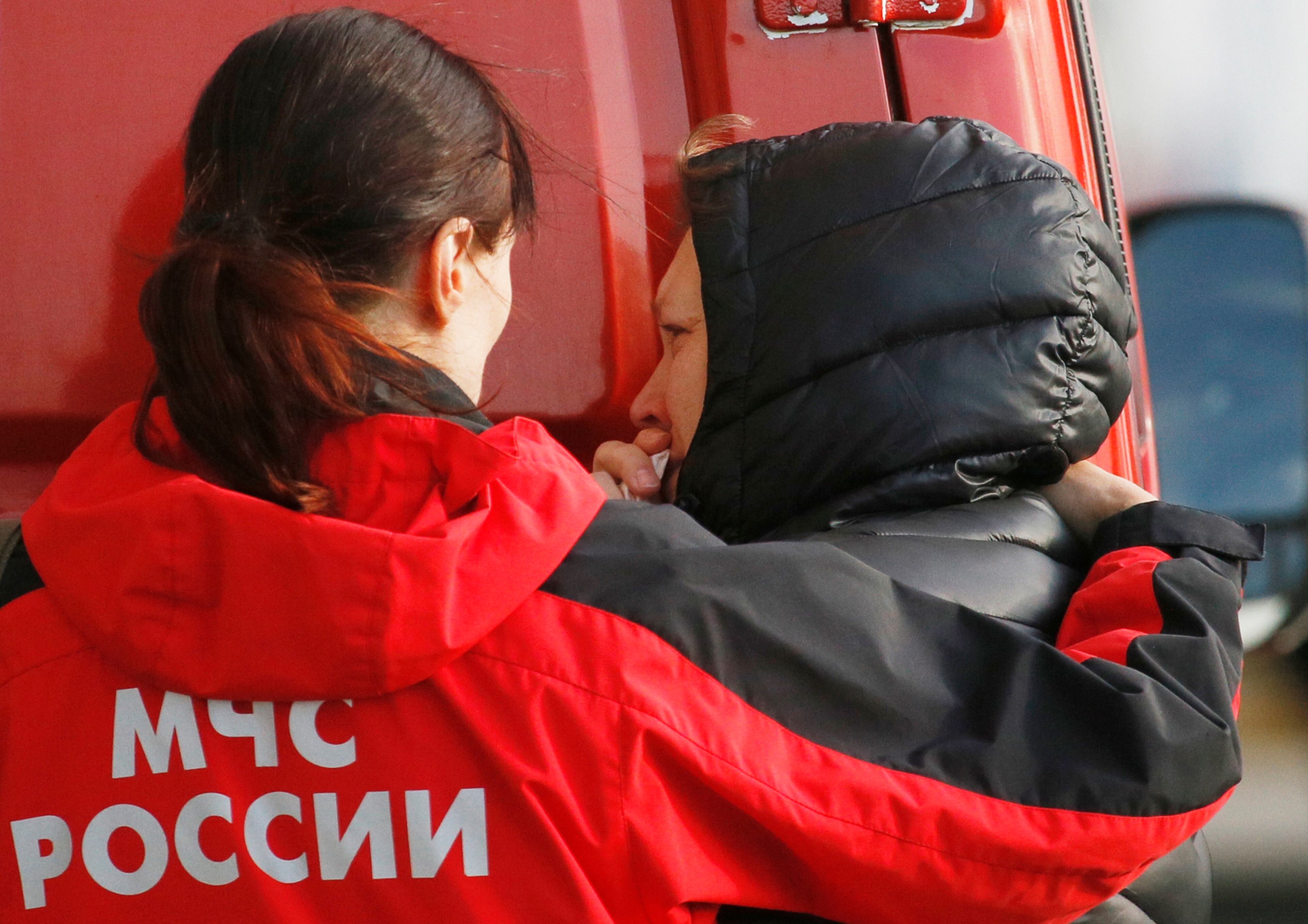 Russian Emergency doctor comforts a relative of a passenger aboard the crashed Russian airliner with 217 passengers and seven crew aboard, as people gather at Pulkovo airport in St.Petersburg, Russia, Saturday, Oct. 31, 2015. Russia's civil air agency is expected to have a news conference shortly to talk about the Russian Metrojet passenger plane that Egyptian authorities say has crashed in Egypt's Sinai peninsula.(AP Photo/Dmitry Lovetsky)