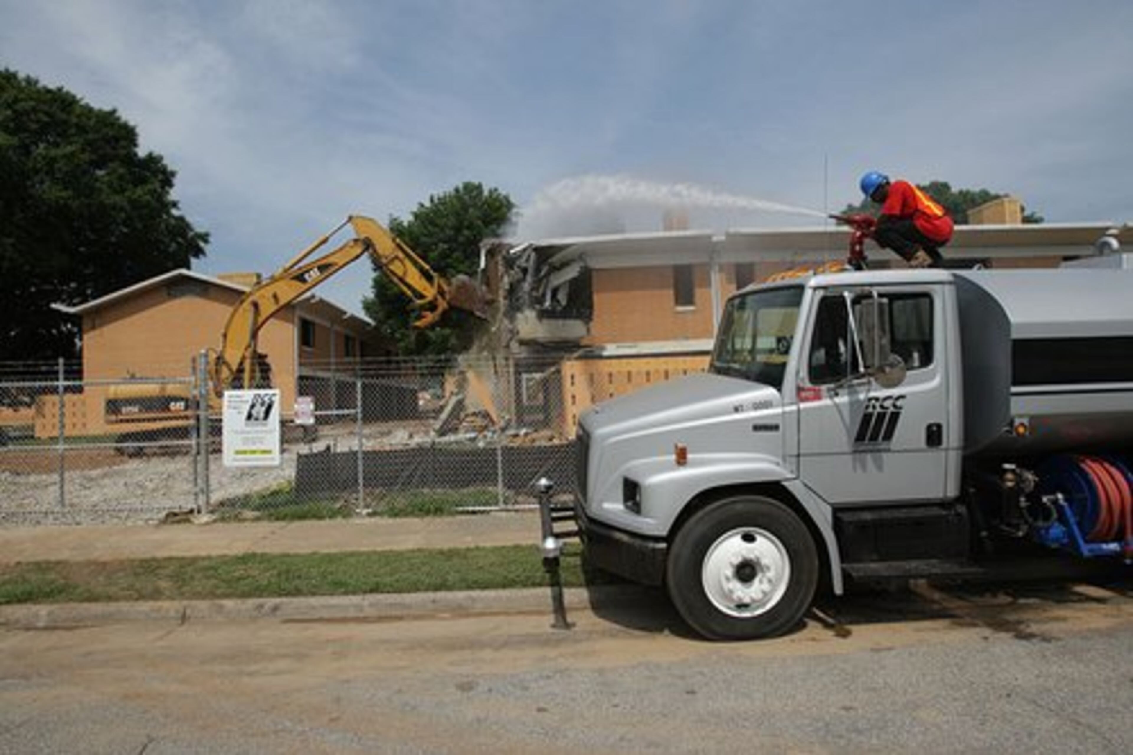 Bowen Homes is no more. The Atlanta Housing Authority began bulldozing the housing project Wednesday. James Riley sprays water to keep the dust down.