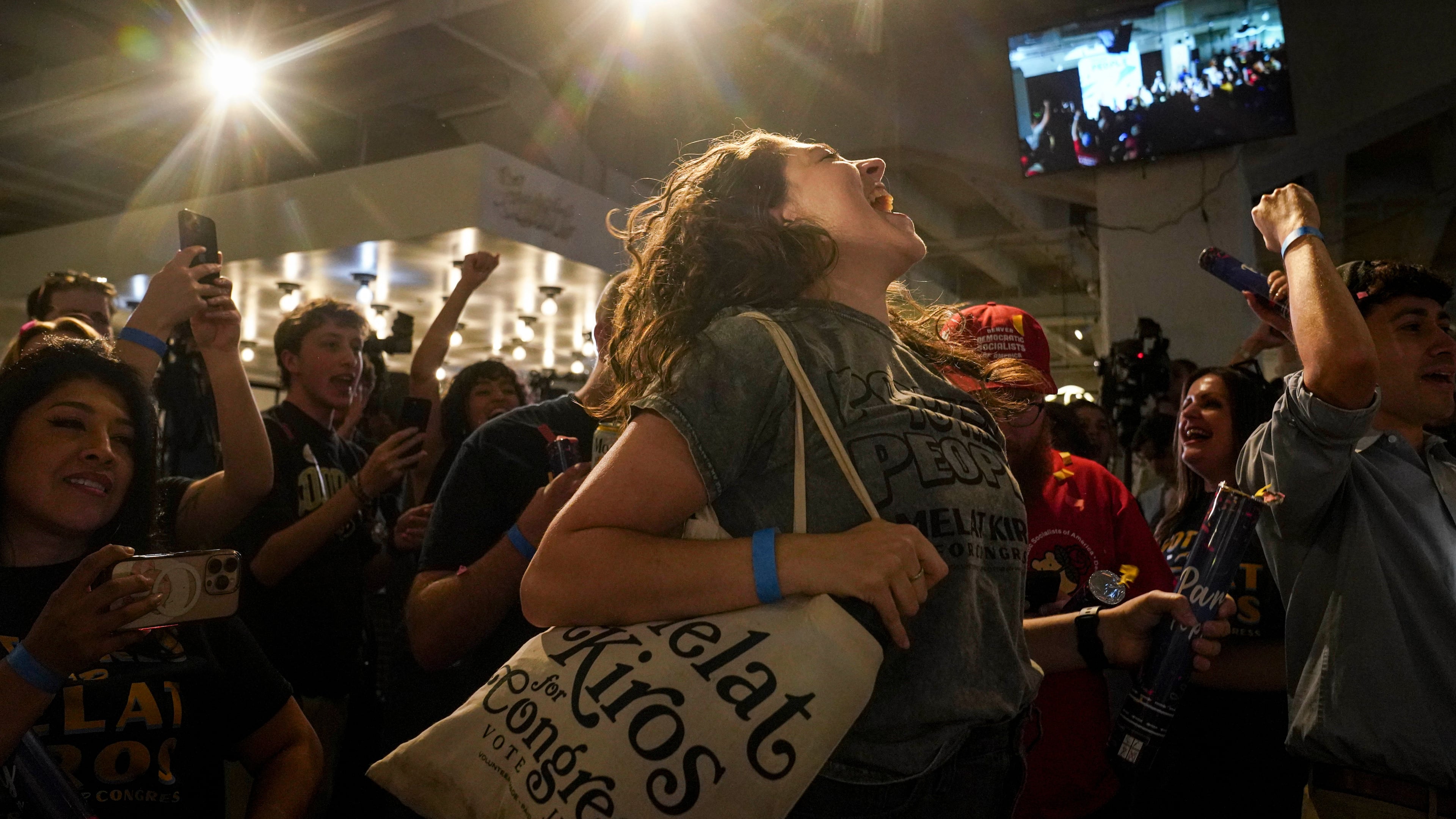 Nikita Valdez jumps while cheering after the first report of the election results show Democratic congressional candidate Melat Kiros in the lead during a primary election night watch party at The Broadway, Tuesday, June 30, 2026, in Denver. (AP Photo/Rebecca Slezak)