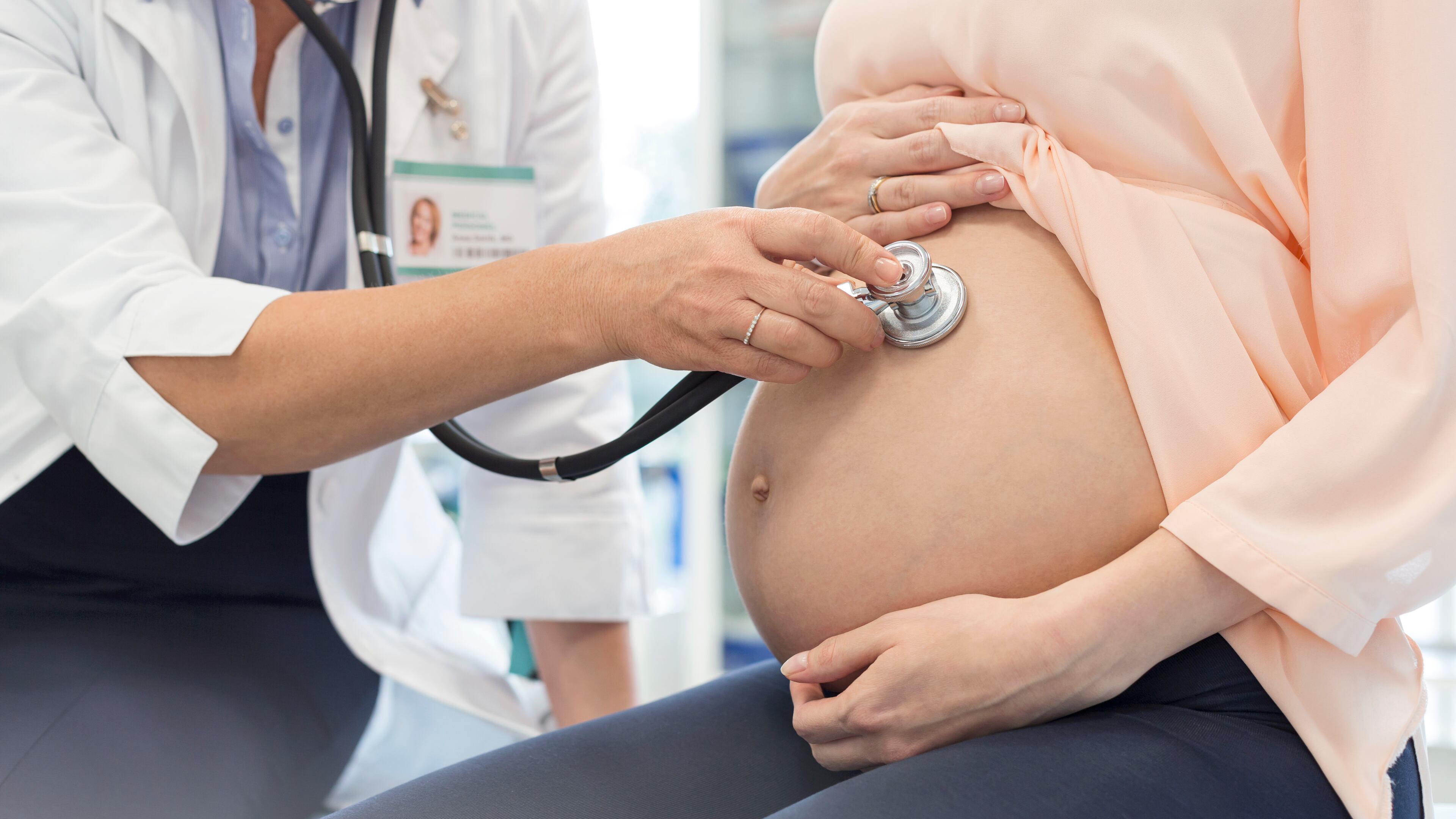 A doctor meets with a pregnant woman