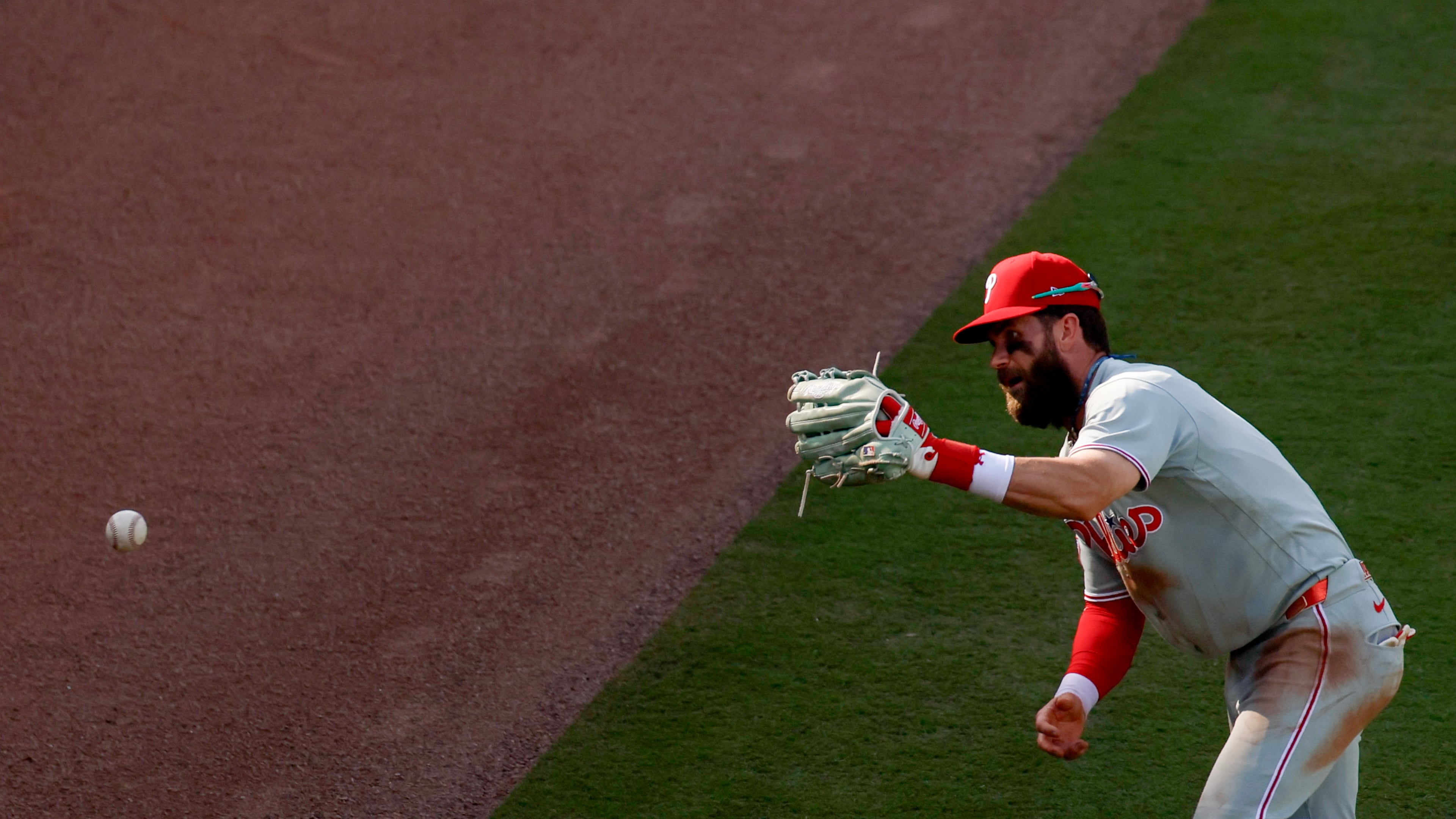 Philadelphia Phillies right fielder Bryce Harper misplays a hit by Atlanta Braves' Drake Baldwin during the seventh inning of Game 2 of a MLB National League Wild Card playoff series between the Atlanta Braves and the Philadelphia Phillies, Wednesday, Sept. 30, 2026, in Atlanta. (Miguel Martinez/AJC)