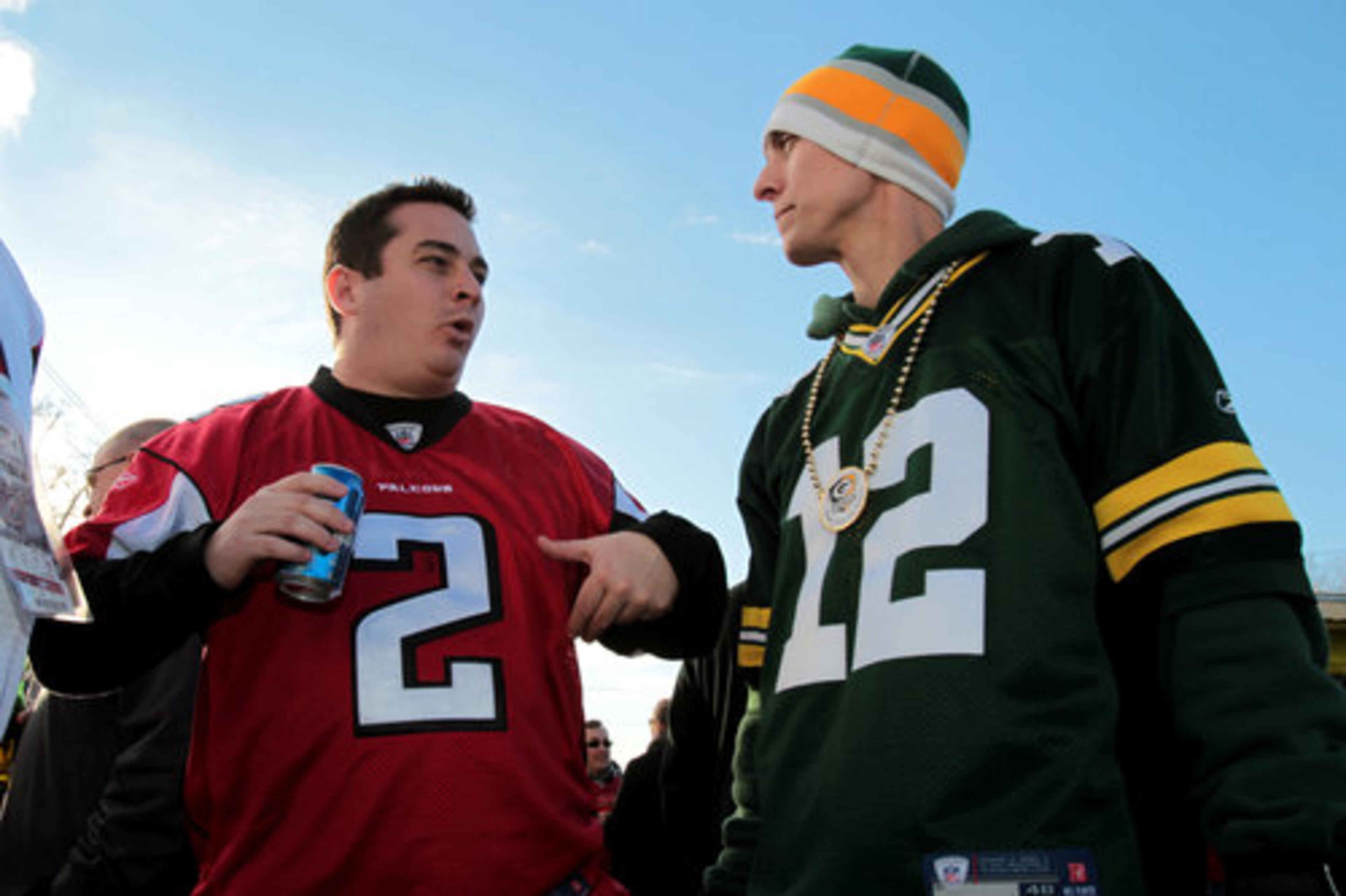 Atlanta Falcon fan Steven Lemos wears a Matt Ryan jersey (2) as he talks with Green Bay Packers fan Jordan Suvak, of Atlanta, wearing a Aaron Rogers jersey (12) in the parking lot outside of the Georgia Dome Saturday afternoon in Atlanta, Ga., Jan. 15, 2011. The Atlanta Falcons host the Green Bay Packers in their NFC divisional playoff game Saturday night.