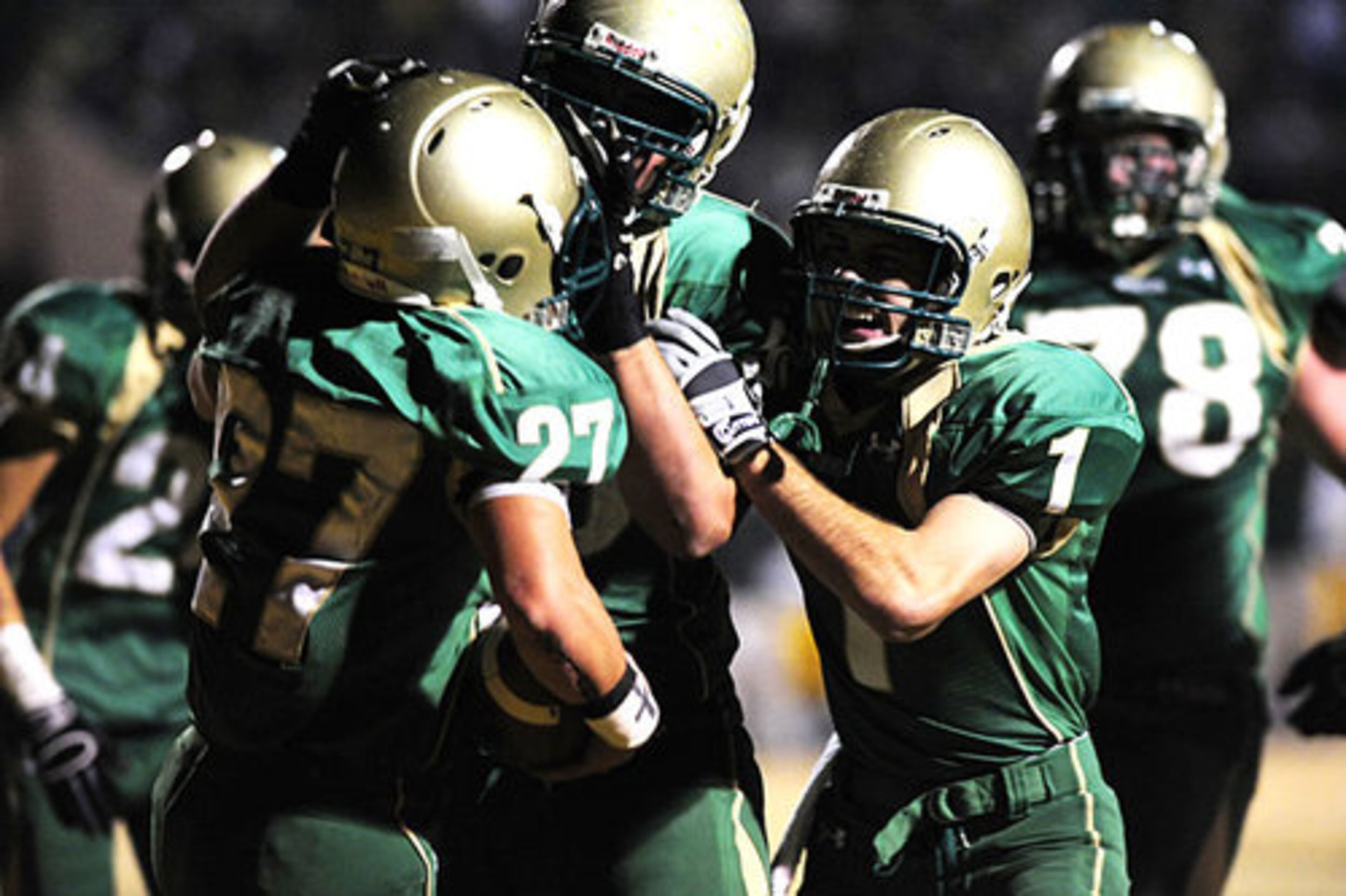 Touchdown, Buford! Cody Getz (27) gives the host Wolves the early lead in Friday night's AA playoff game against Dublin. (From left) Tanner West and Ryan Reed join Nix in the celebration.
