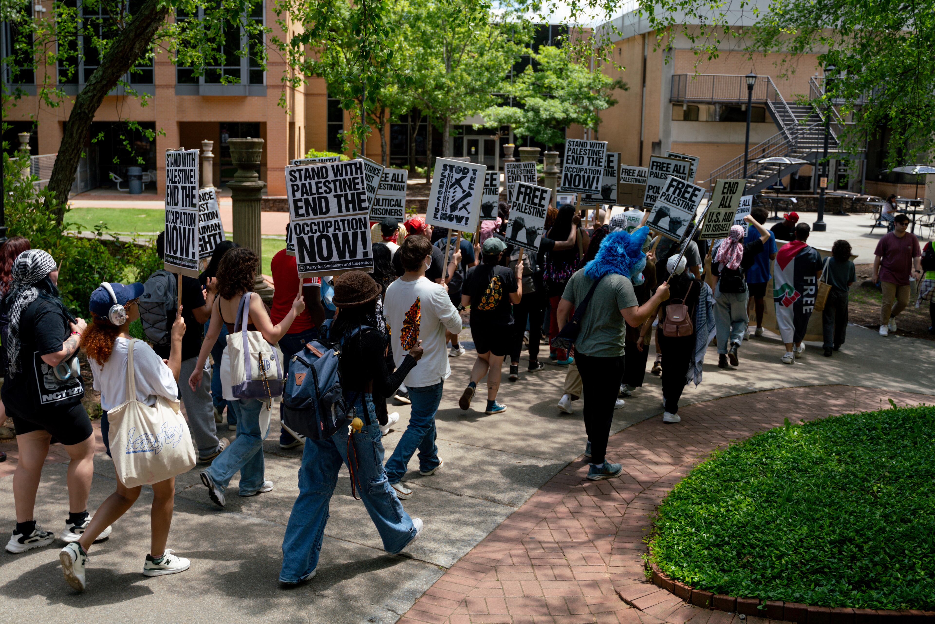 Kennesaw State University students march across campus in May 2024.