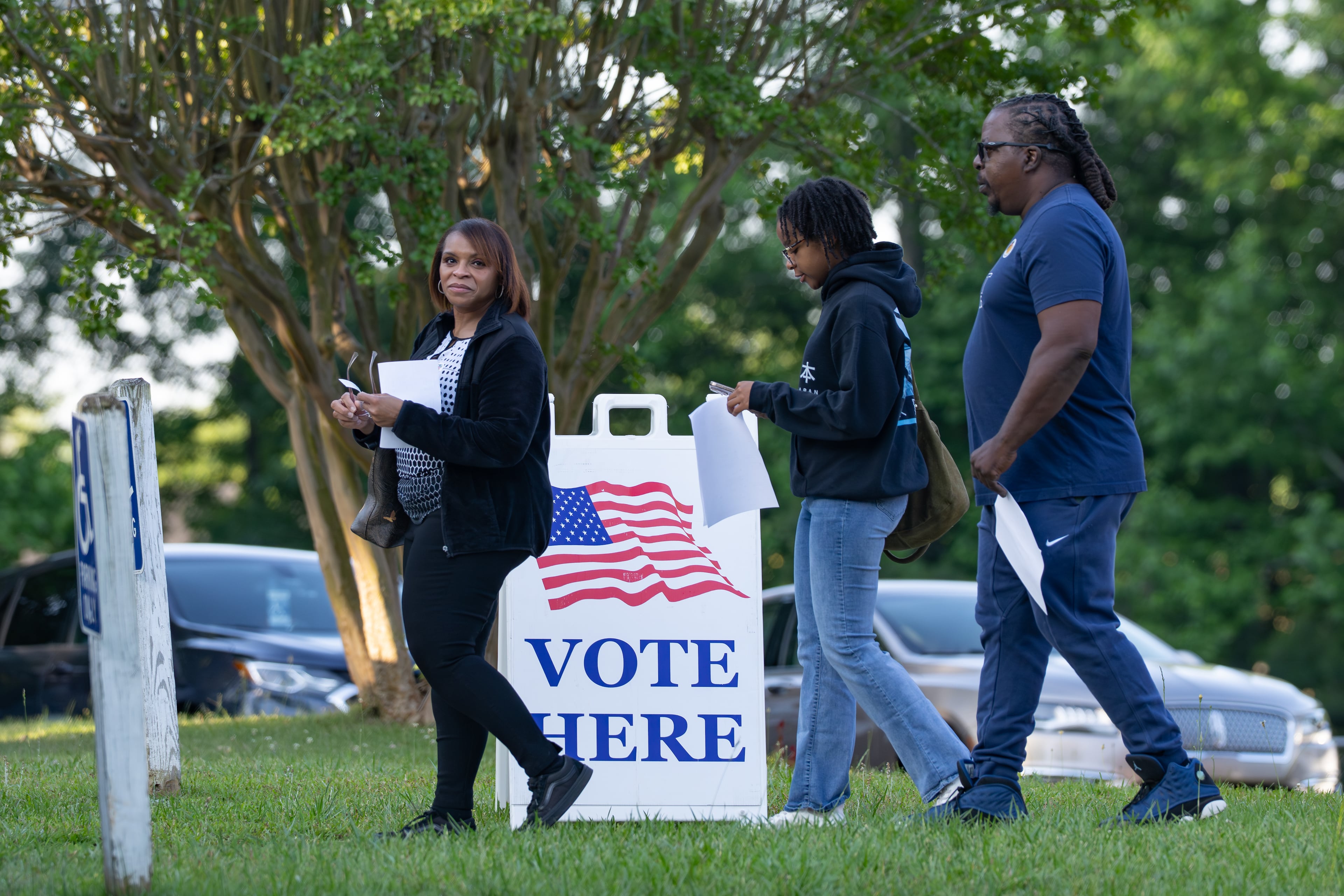 A family leaves the Trinity United Methodist Church polling location after voting. Tuesday, May 19, 2026 (Ben Hendren for the AJC)