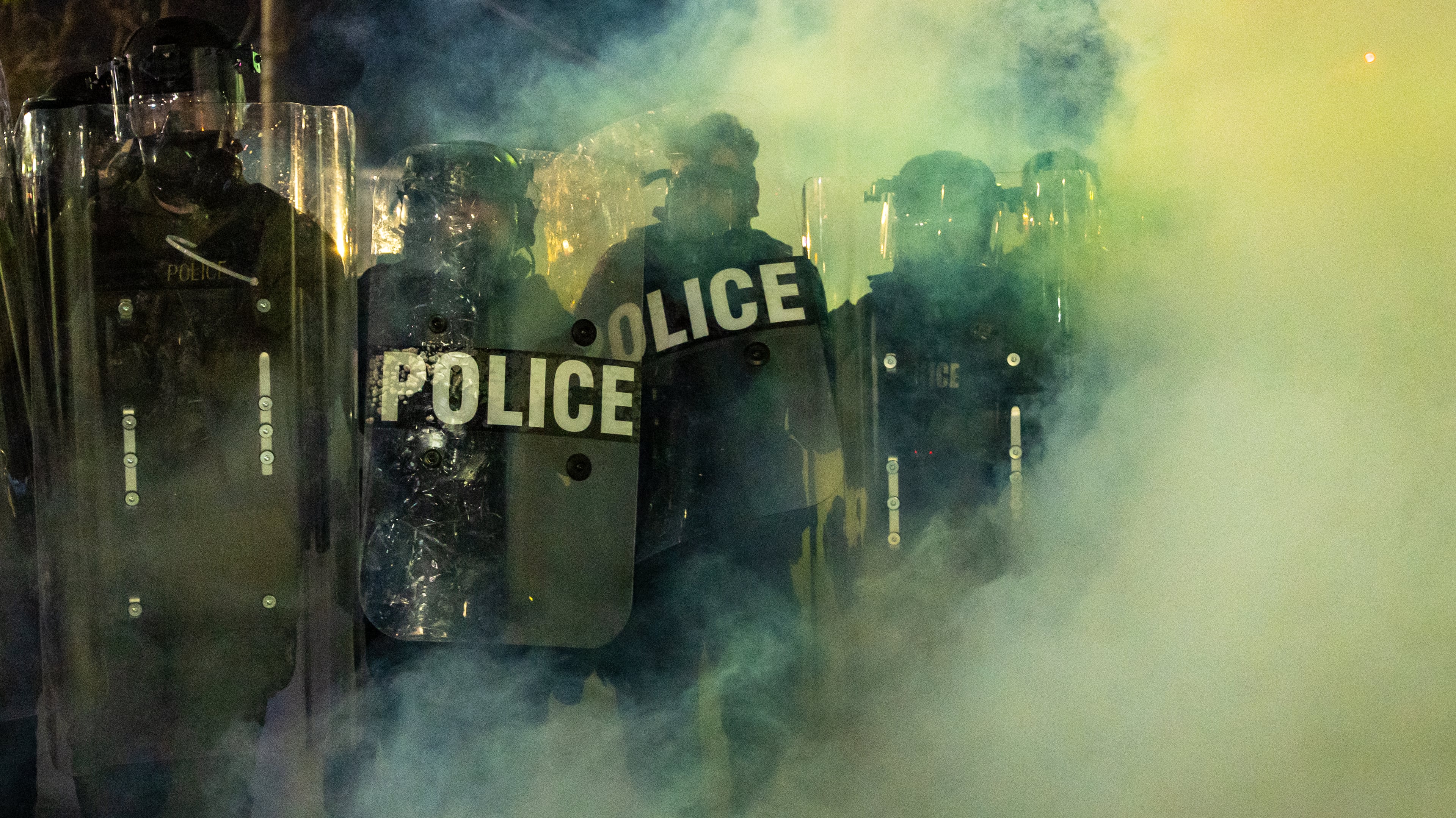Law Enforcement Officers walk through tear gas chemical irritant during clashes with anti-ICE protesters outside the Delaney Hall detention center on Saturday, May 30, 2026, in Newark, N.J. (AP Photo/Angelina Katsanis)