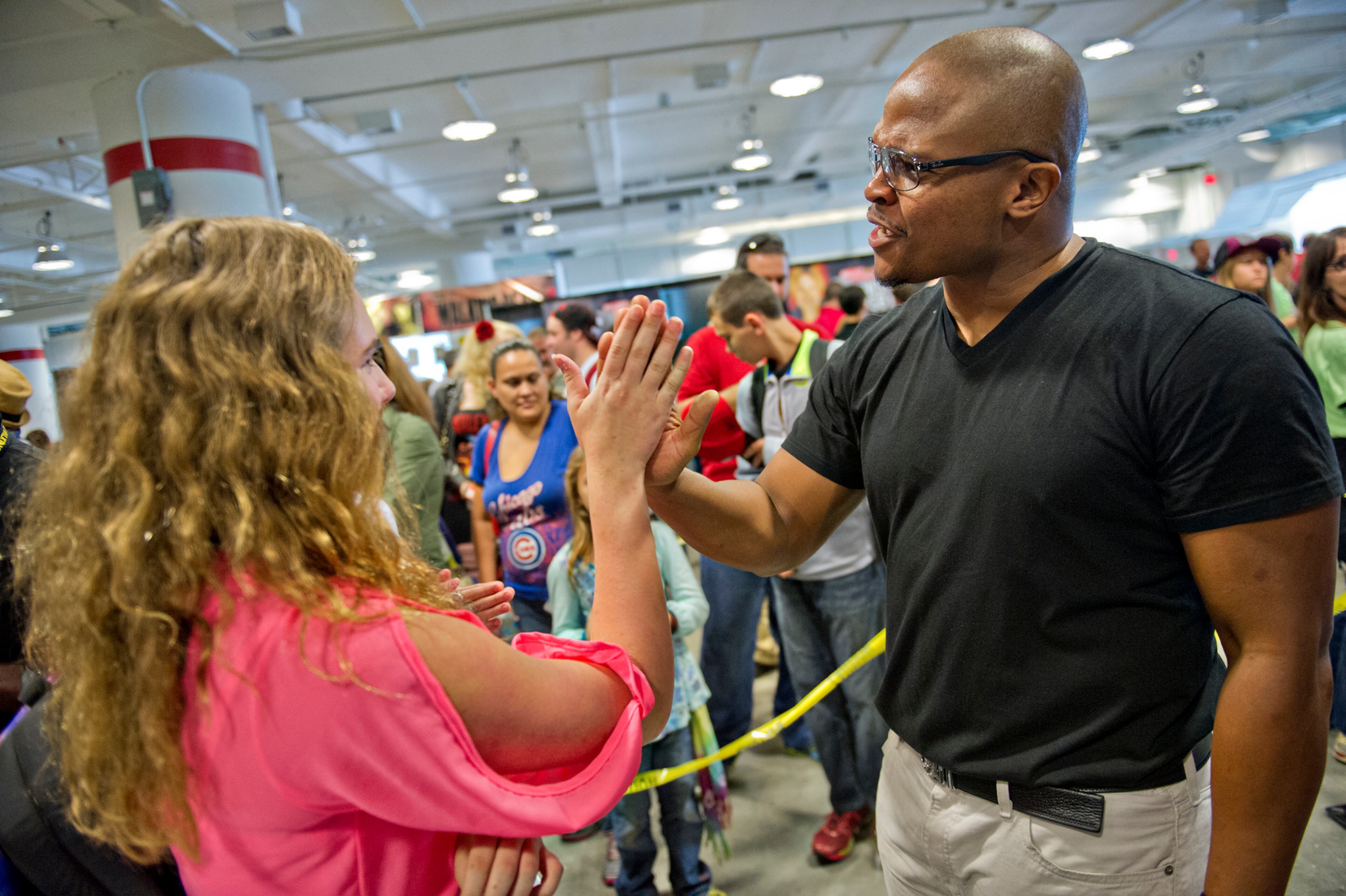 IronE Singleton (right), who played T-Dog on the Walking Dead, gives a high-five to Lauren Evans during Walker Stalker Con on Sunday, Oct. 19, 2014. For three days fans got the chance to immerse themselves in all things Walking Dead and zombies. JONATHAN PHILLIPS / SPECIAL