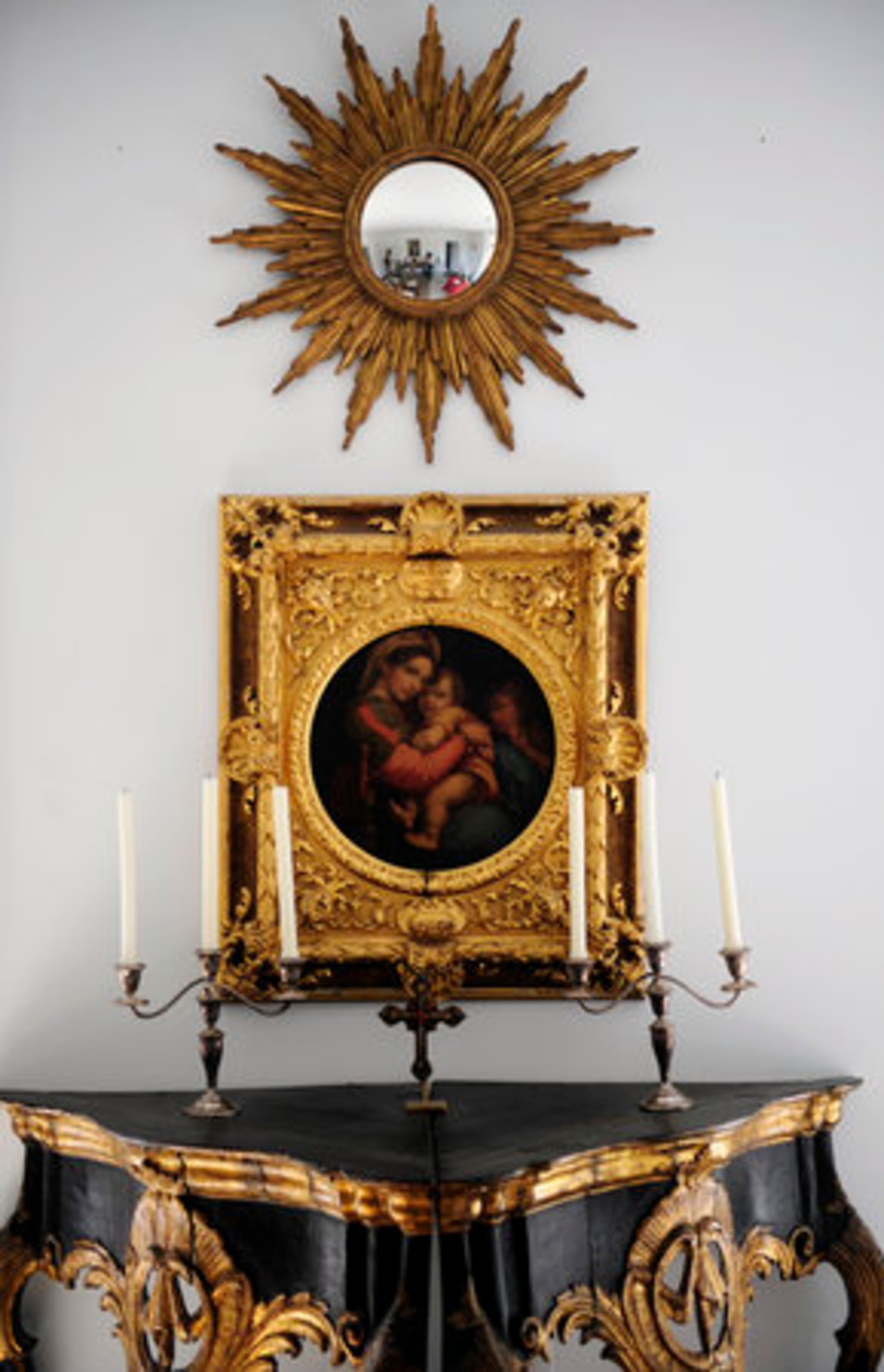 A fisheye mirror in a sunburst frame tops the ornate vintage Madonna that numbers among Cook's Russian artifacts.