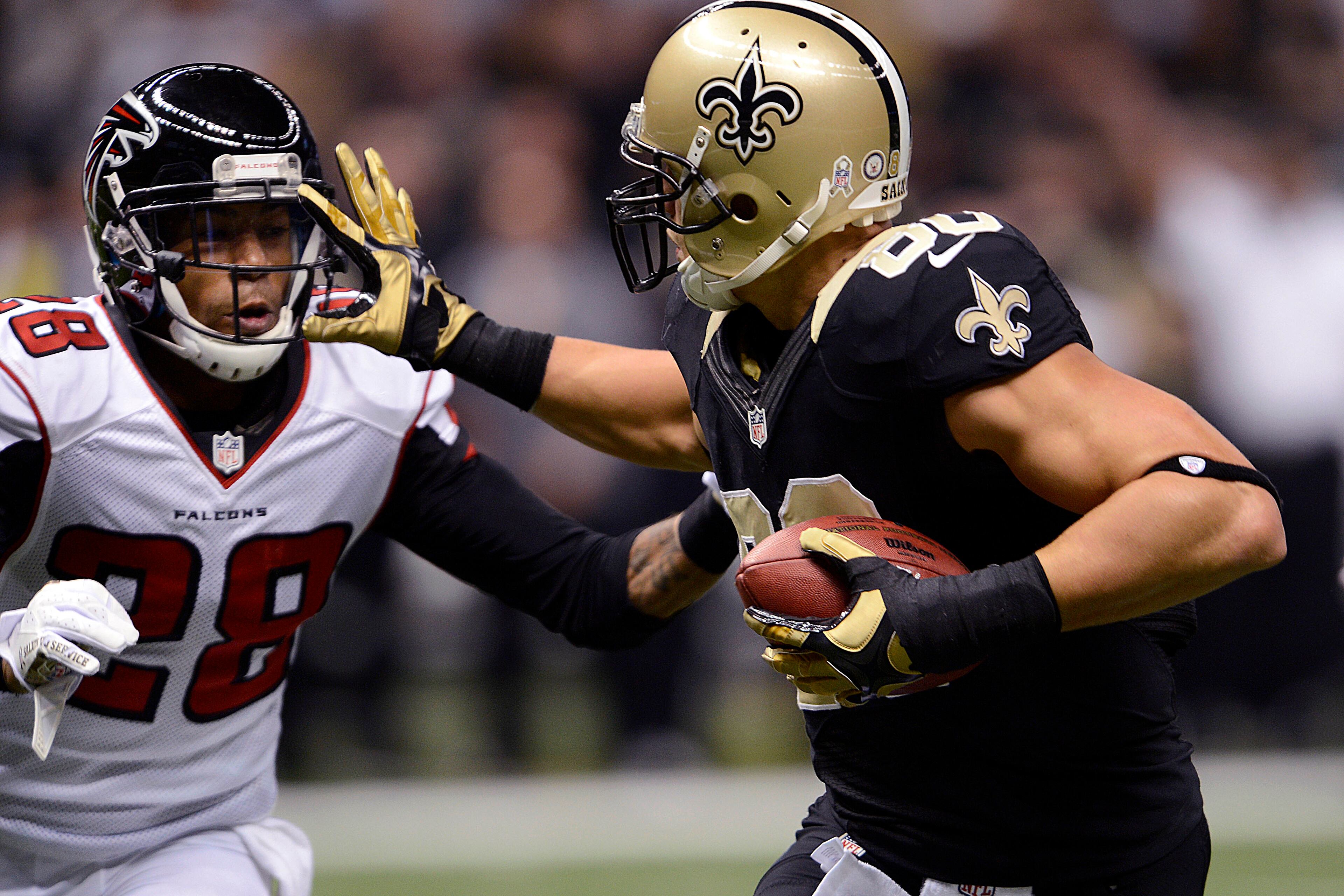 New Orleans Saints tight end Jimmy Graham, right, carries and reaches to push off Atlanta Falcons free safety Thomas DeCoud (28) on a touchdown reception in the first half an NFL football game at the Mercedes-Benz Superdome in New Orleans, Sunday, Nov. 11, 2012. (AP Photo/Bill Feig)