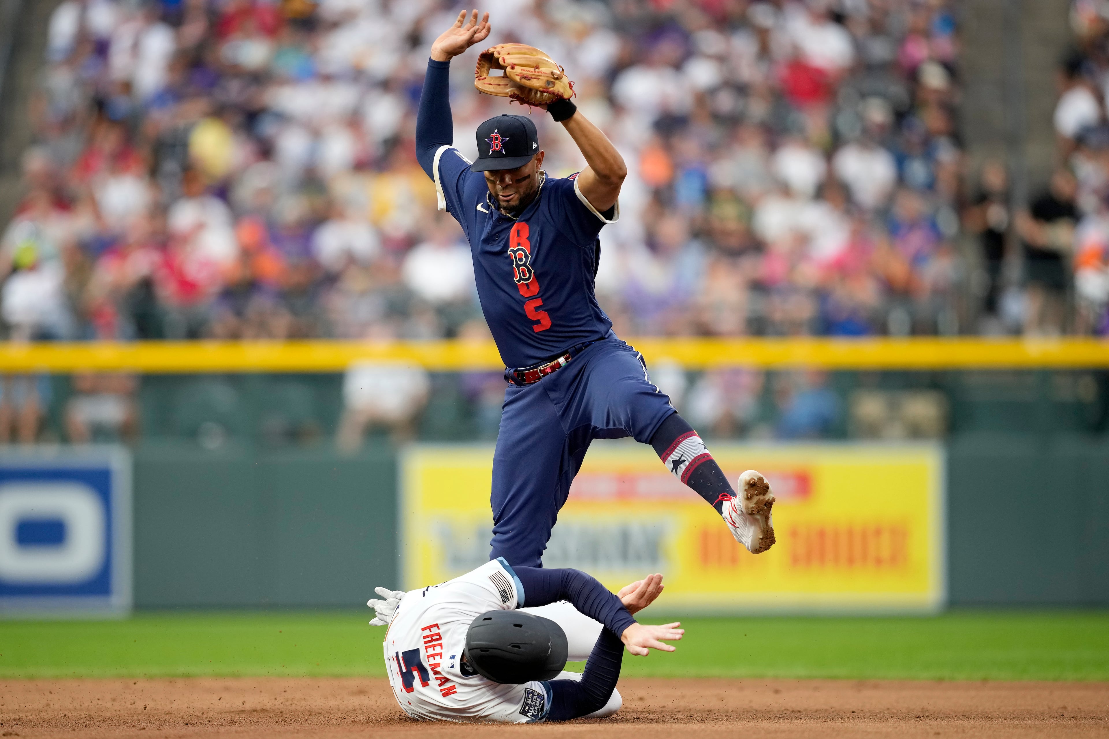 National League's Freddie Freeman, of the Atlanta Braves, (5) is forced out at second by Xander Bogaerts, of the Boston Red Sox, on a double play hit into by Nick Castellanos, of the Cincinnati Reds, during the fourth inning of the MLB All-Star baseball game, Tuesday, July 13, 2021, in Denver. (AP Photo/David Zalubowski)