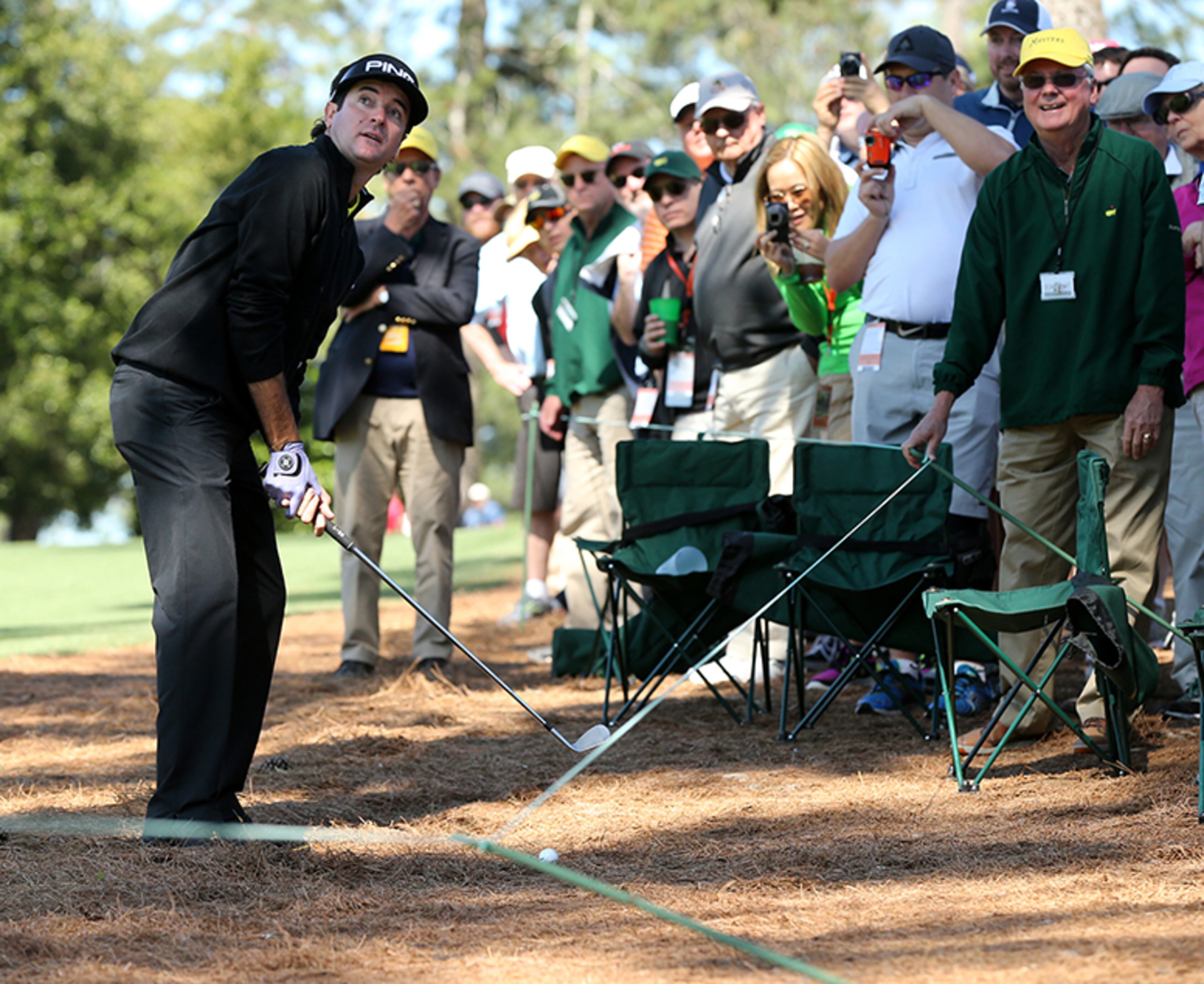 The gallery looks on as two-time Masters champion Bubba Watson prepares to hit his second shot over the trees on the 9th hole after hitting his drive into the woods during his practice round at Augusta National Golf Club on Tuesday, April 5, 2016, in Augusta.