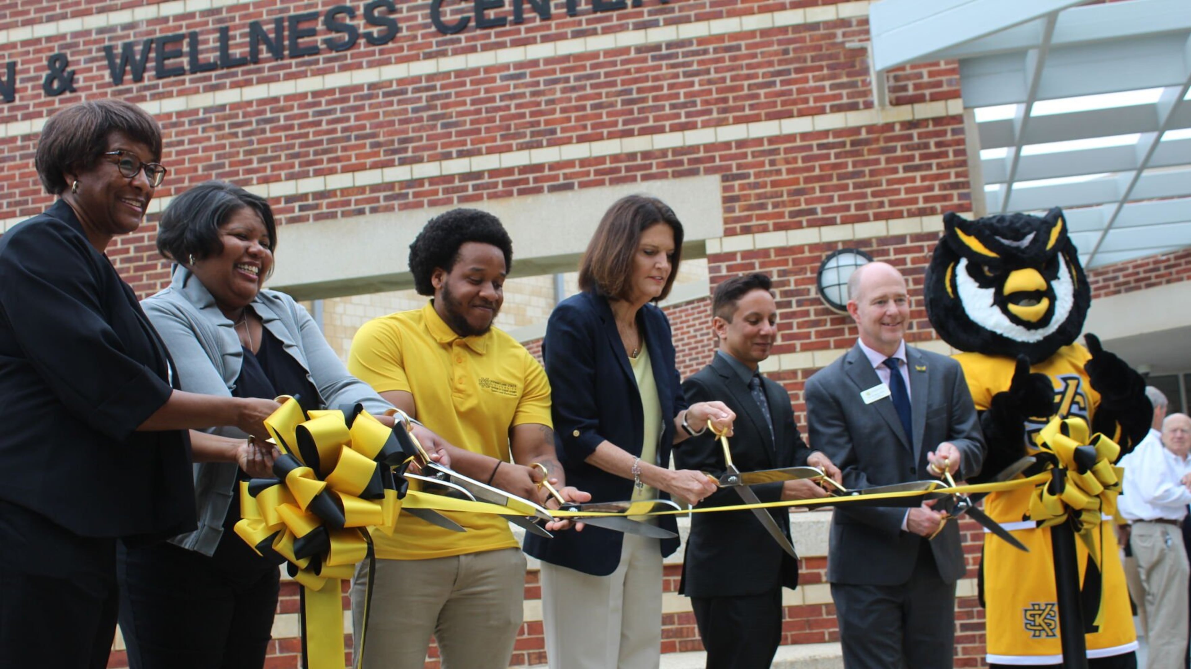 From left: Tara Parker, KSU’s executive director of sports and recreation, Marcy Stadium, assistant vice president of student affairs, KSU senior Billy Anderson, KSU President Kathy “Kat” Schwaig, KSU Provost Ivan Pulinkala, and KSU Vice President for Student Affairs Eric Arneson, alongside Scrappy the Owl, cut the ribbon on the renovated recreation and wellness center on KSU’s Marietta campus on Tuesday, Aug. 29.
