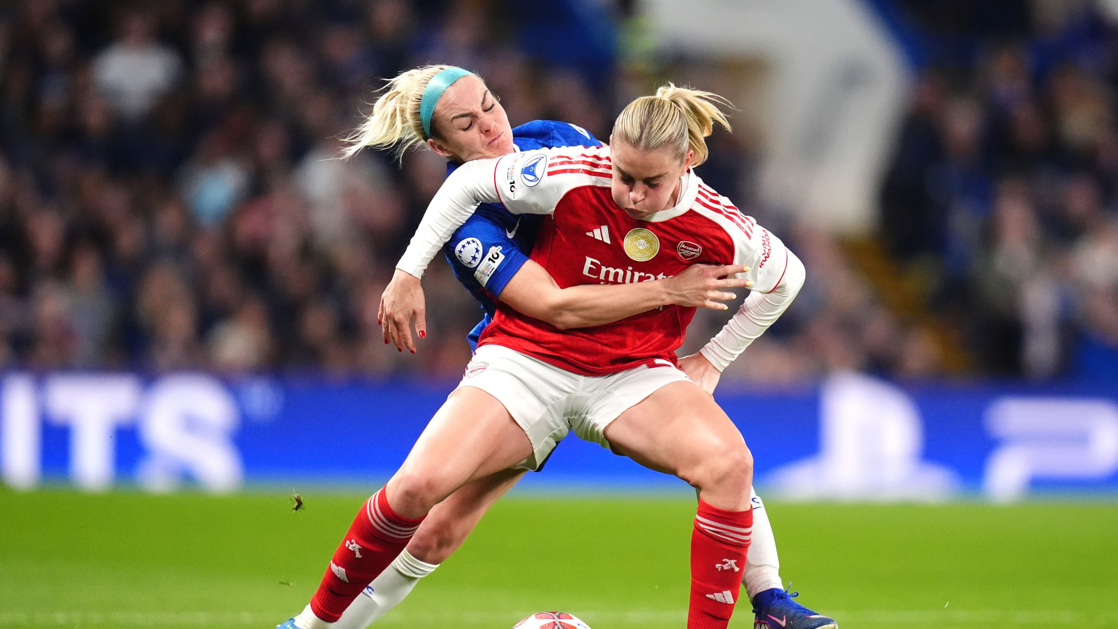 Arsenal's Alessia Russo, left, and Chelsea's Ellie Carpenter battle for the ball during the Women's Champions League quarterfinal second leg soccer match between Chelsea and Arsenal in London, Wednesday, April 1, 2026. (John Walton/PA via AP)