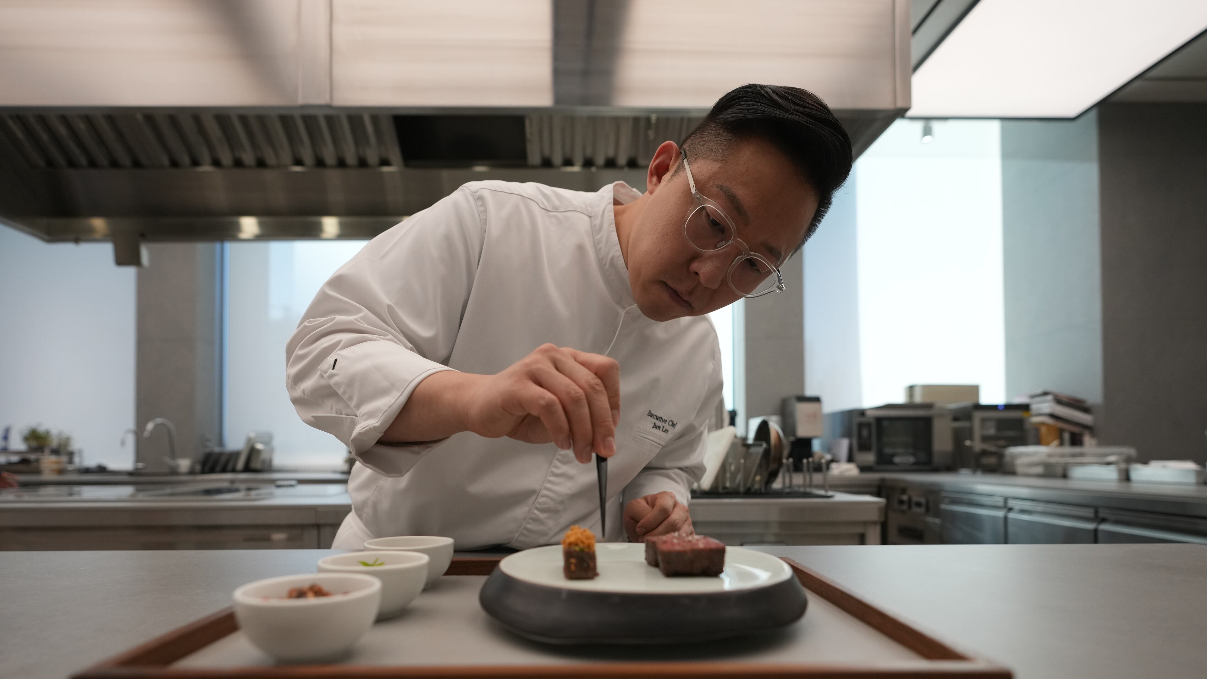Chef Jun Lee prepares food for a photo at his restaurant SOIGNÉ in Seoul, South Korea, Thursday, Jan. 29, 2026. (AP Photo/Lee Jin-man)