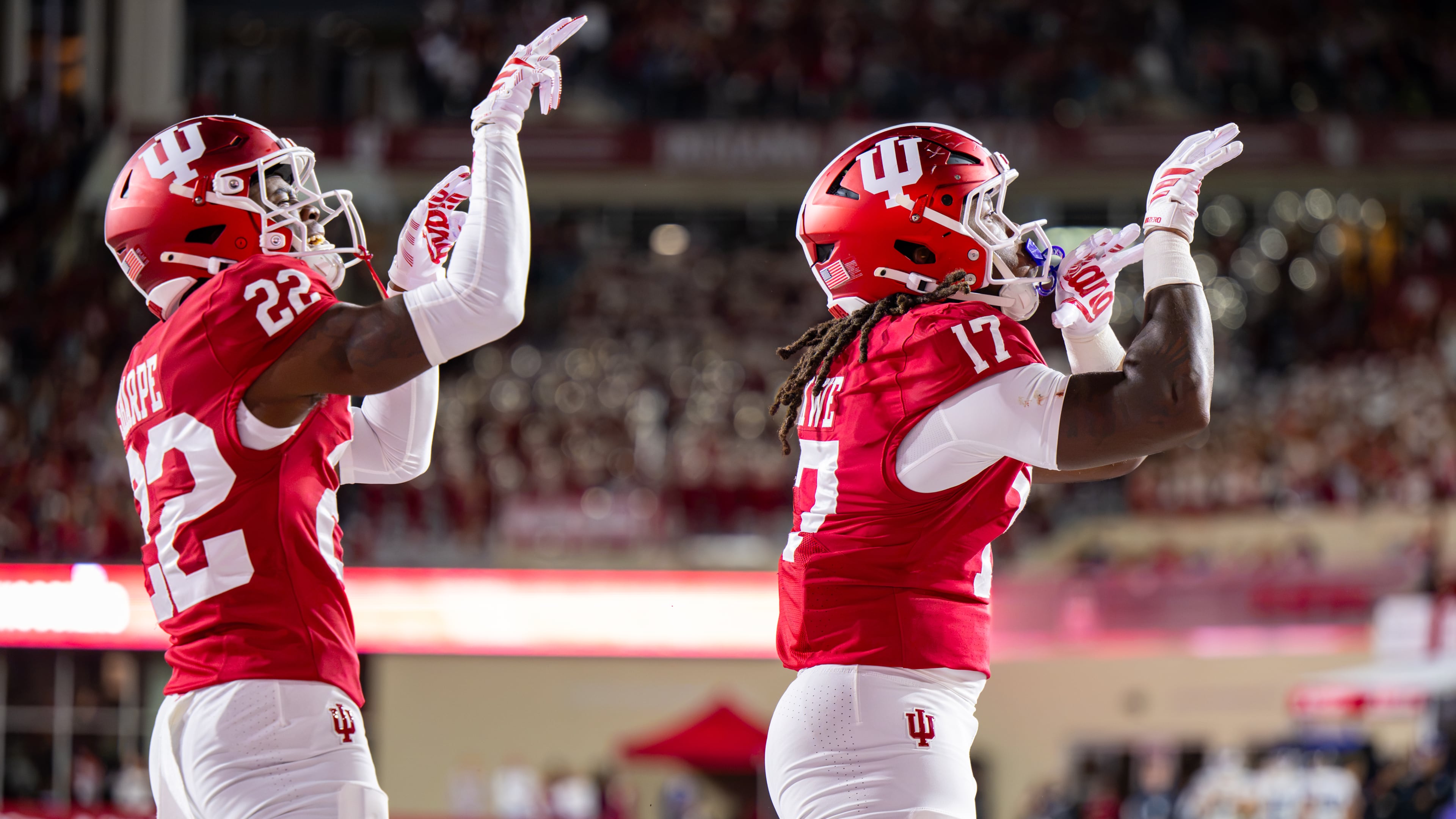 Indiana defensive back Jamari Sharpe (22) and defensive lineman Daniel Ndukwe (17) react after scoring a safety against Northwestern during the first half of an NCAA college football game, Friday, Sept. 25, 2026, in Bloomington, Ind. (AP Photo/Doug McSchooler)