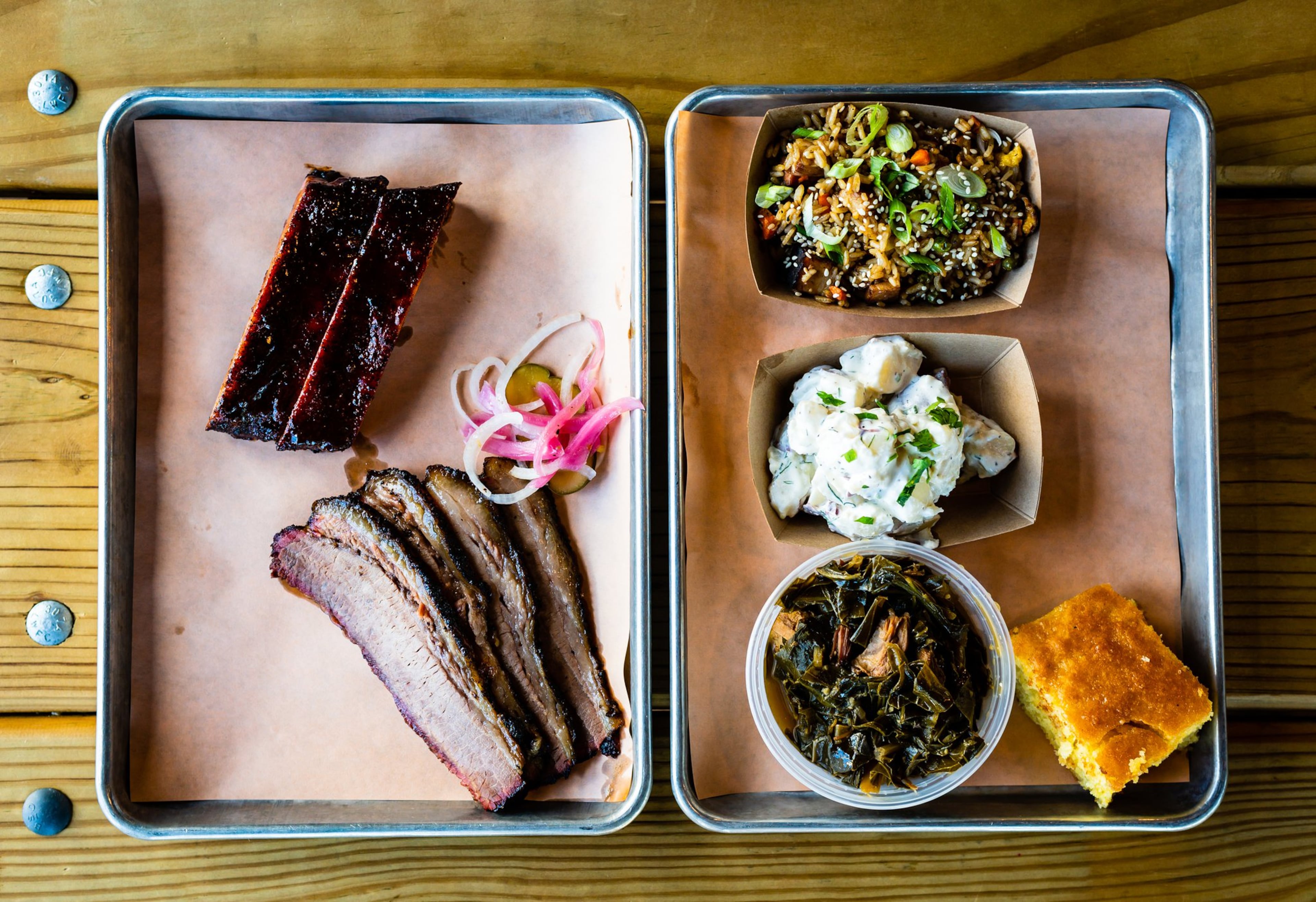 A two-meat plate of St. Louis-style pork ribs and beef brisket with three sides and cornbread.. The two-meat plate typically includes two sides. CONTRIBUTED / HENRI HOLLIS