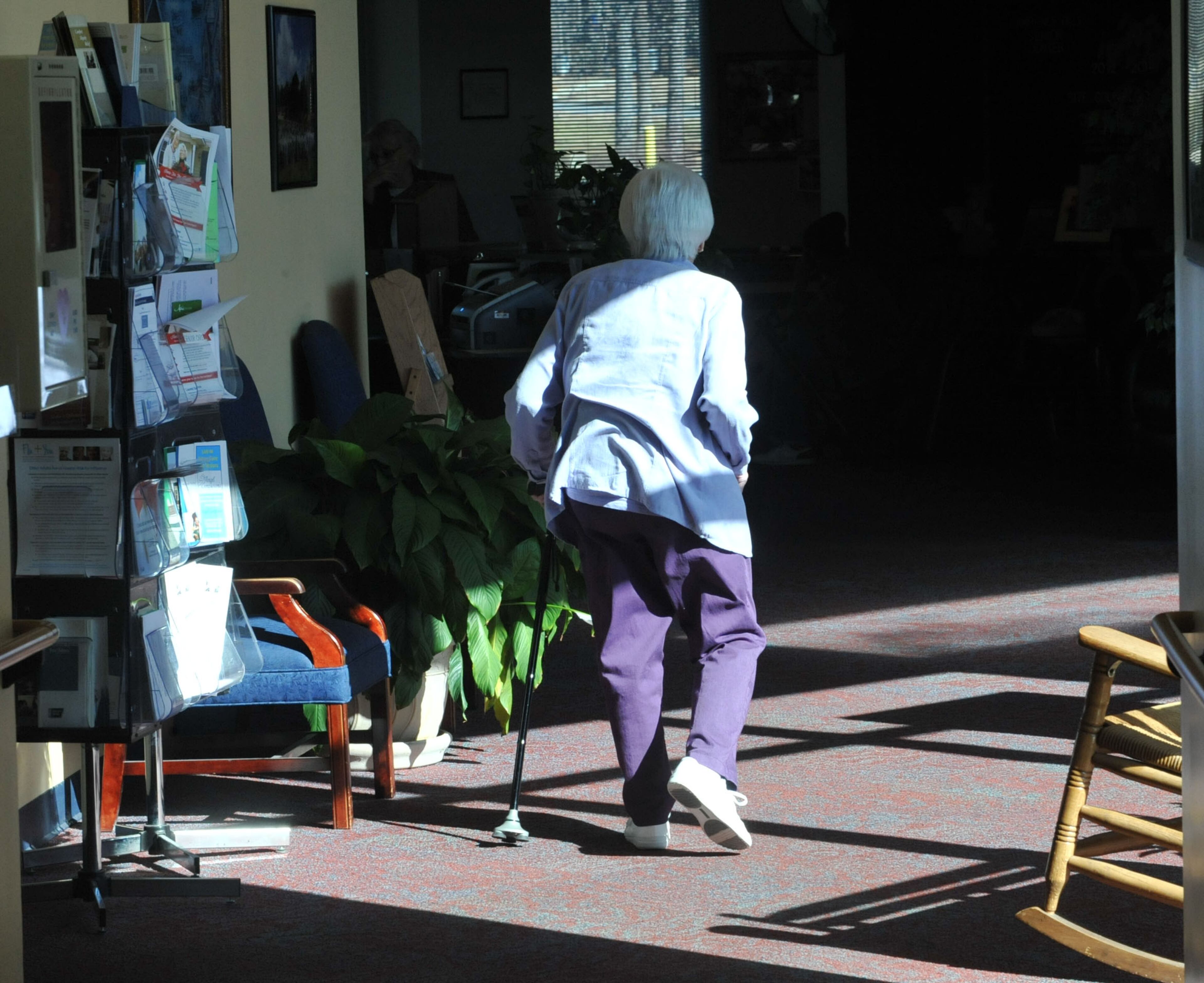 A woman walks through the sitting area at the Lawrenceville Senior Center.