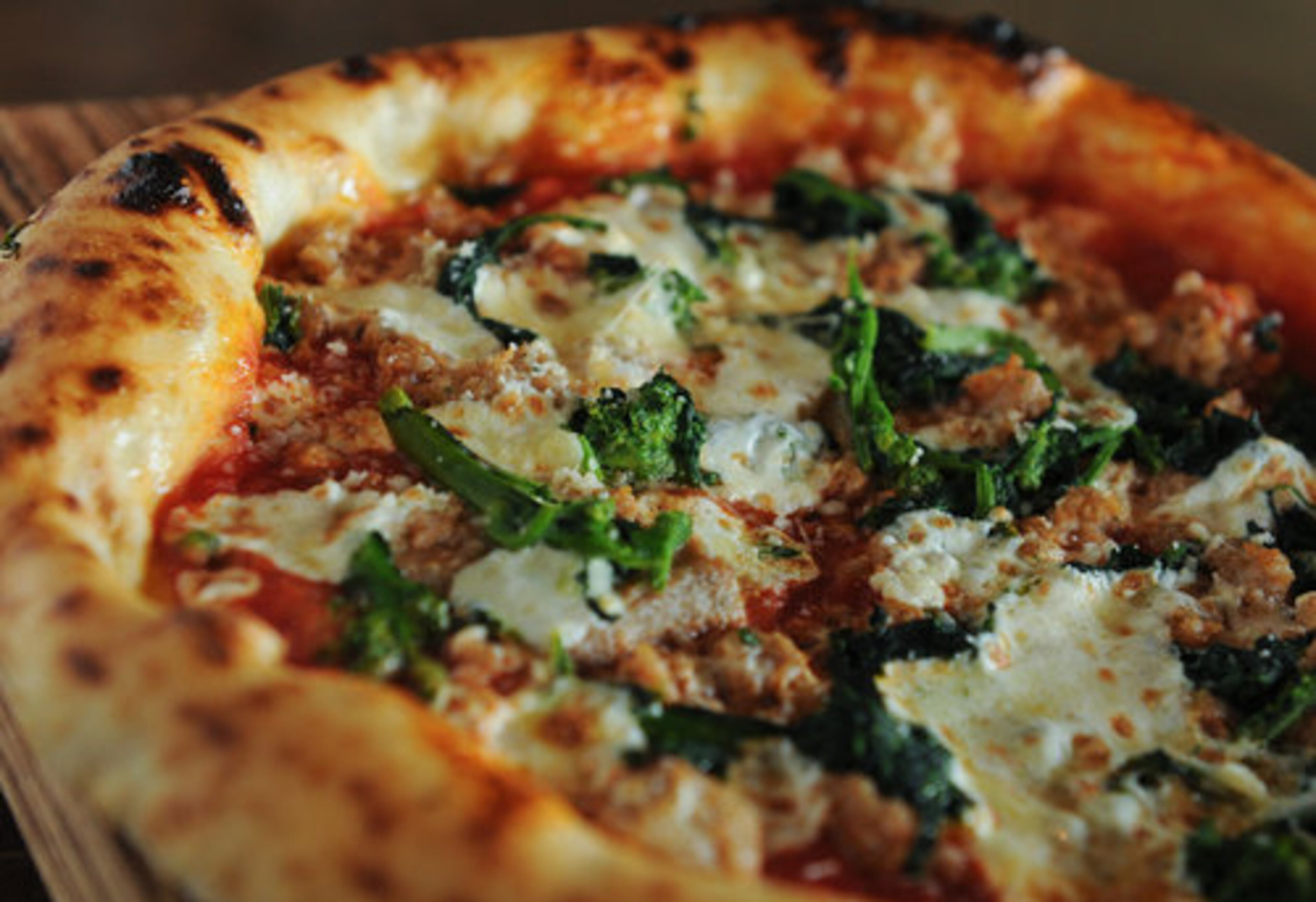 The Salsiccia e broccoli pie with san marzano tomato, mozzarella, local sausage and broccoli rabe from Cibo e Beve in Sandy Springs. John Kessler writes, " It isn't exactly an Italian restaurant...but it nonetheless serves as a decent neighborhood spot for assorted comestibles that reference Italy with good cheer, if sometimes too much razzamatazz." Two stars.