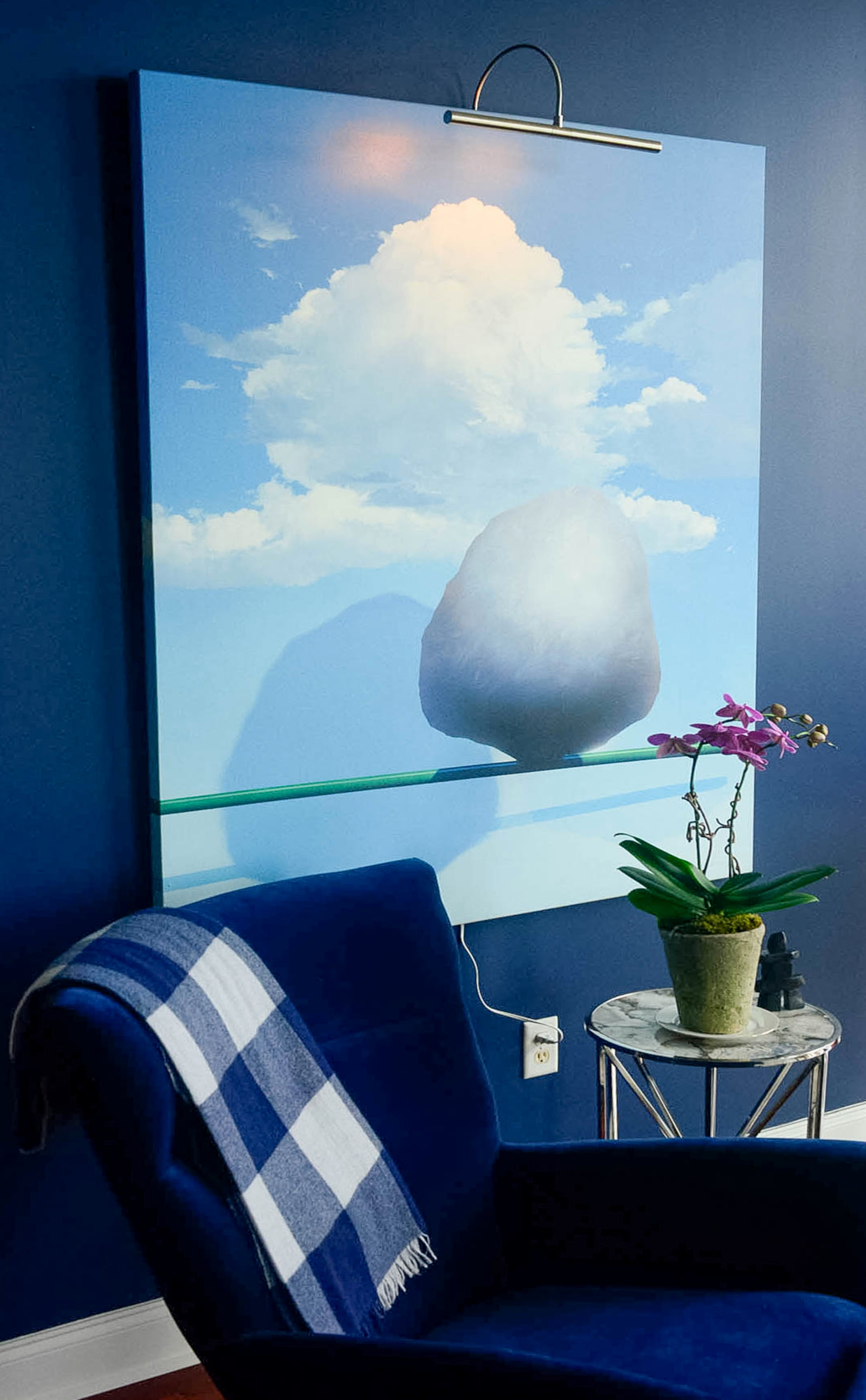 A baby grand piano, chandelier from Lighting Loft and bursts of red against gray walls add drama to the music nook overlooking the city.