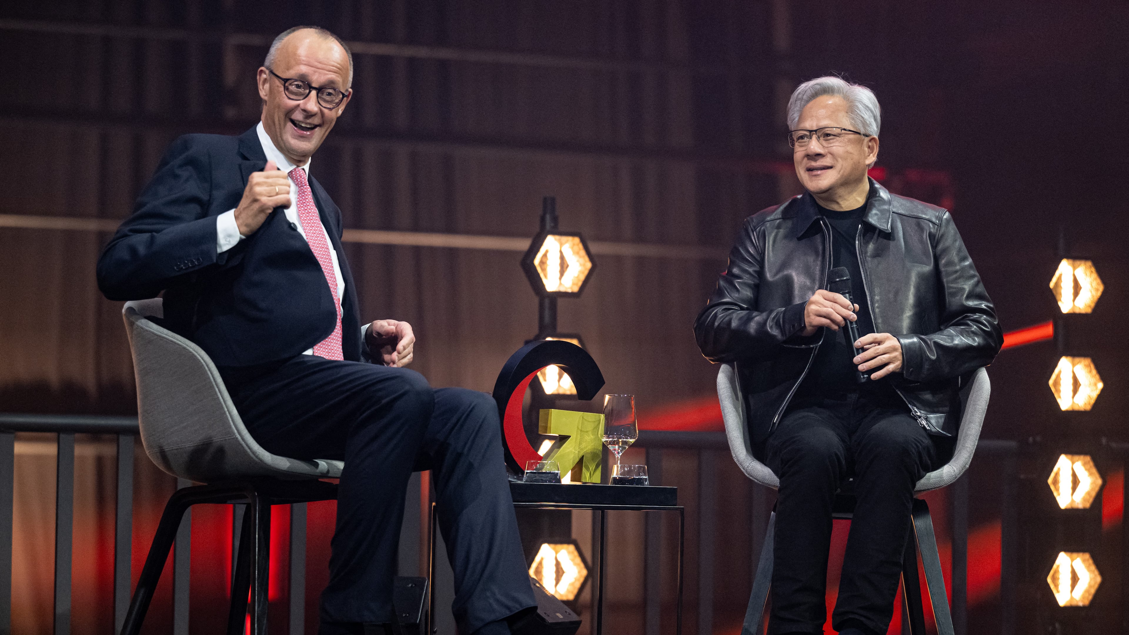 German Chancellor Friedrich Merz, left, and Nvidia CEO Jensen Huang, attend the opening ceremony of the "Invest in Germany Summit" in Berlin, Monday, Oct. 19, 2026. (Fabian Sommer/dpa via AP)