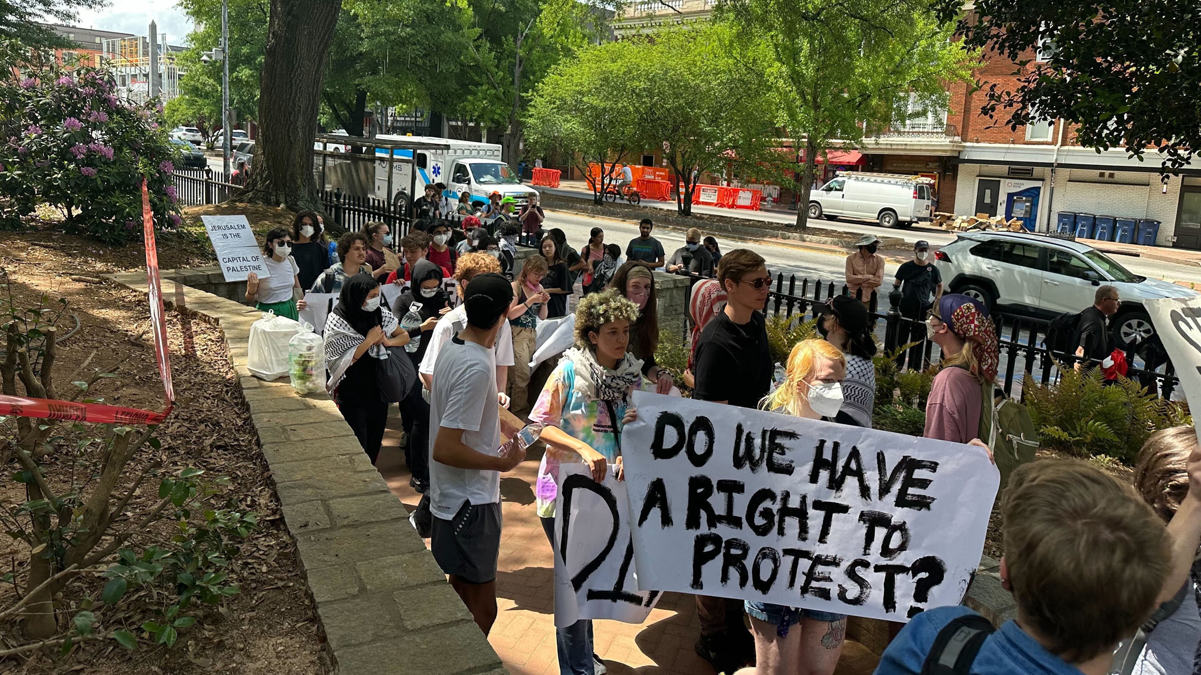 Demonstrators protesting the Israel-Hamas war in Gaza carry a banner asking "Do we have a right to protest?" at the University of Georgia on April 29. The University System of Georgia on July 1 published its annual free speech report, which stated that schools prepared extensively for campus protests. (Fletcher Page/AJC file photo)