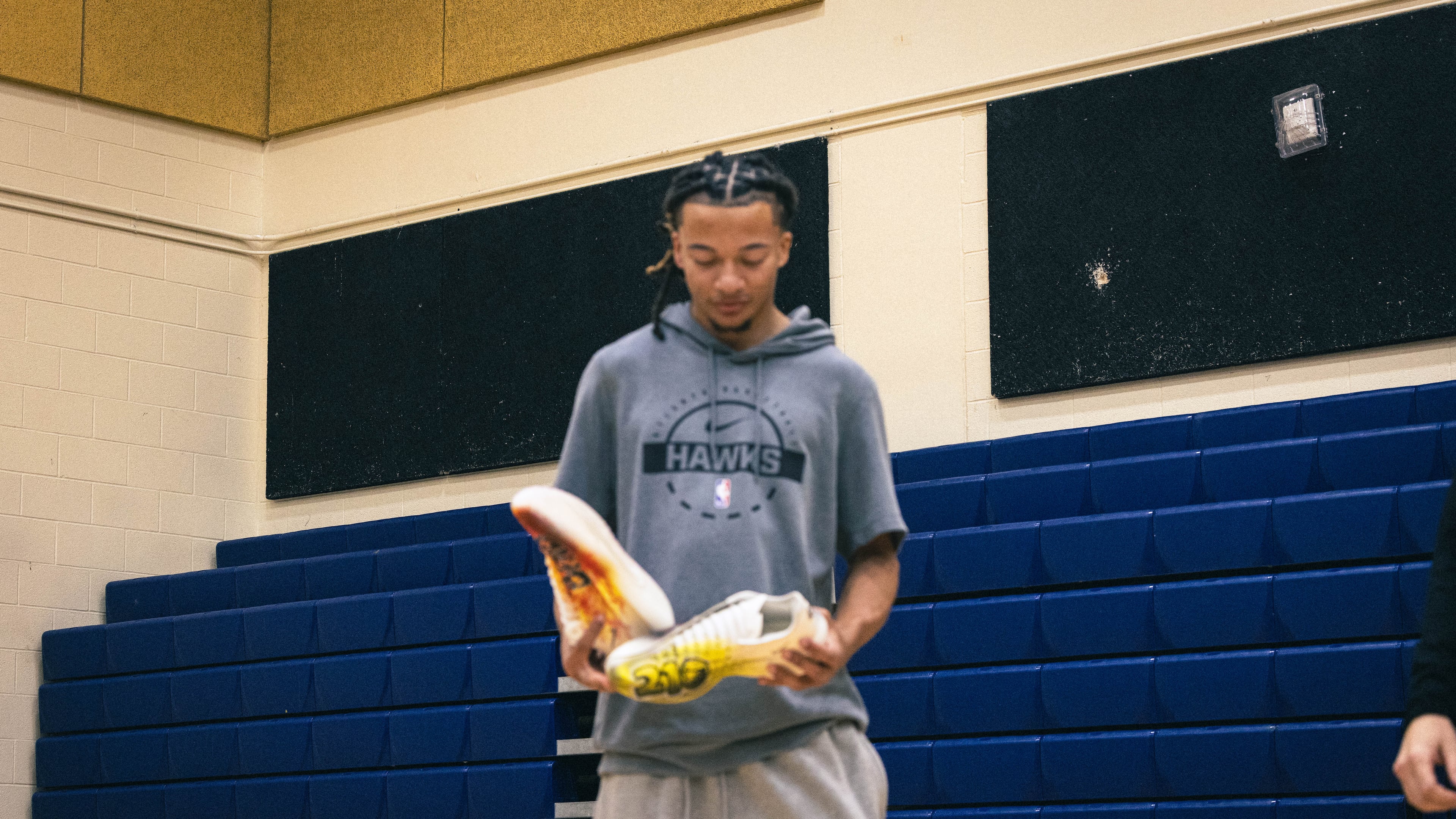 Kingston Flemings looks at custom shoes gifted to him by his father at Brennan High School in San Antonio, Texas on Oct. 7, 2026. (Nikee Moore/Courtesy of MarkItMe)