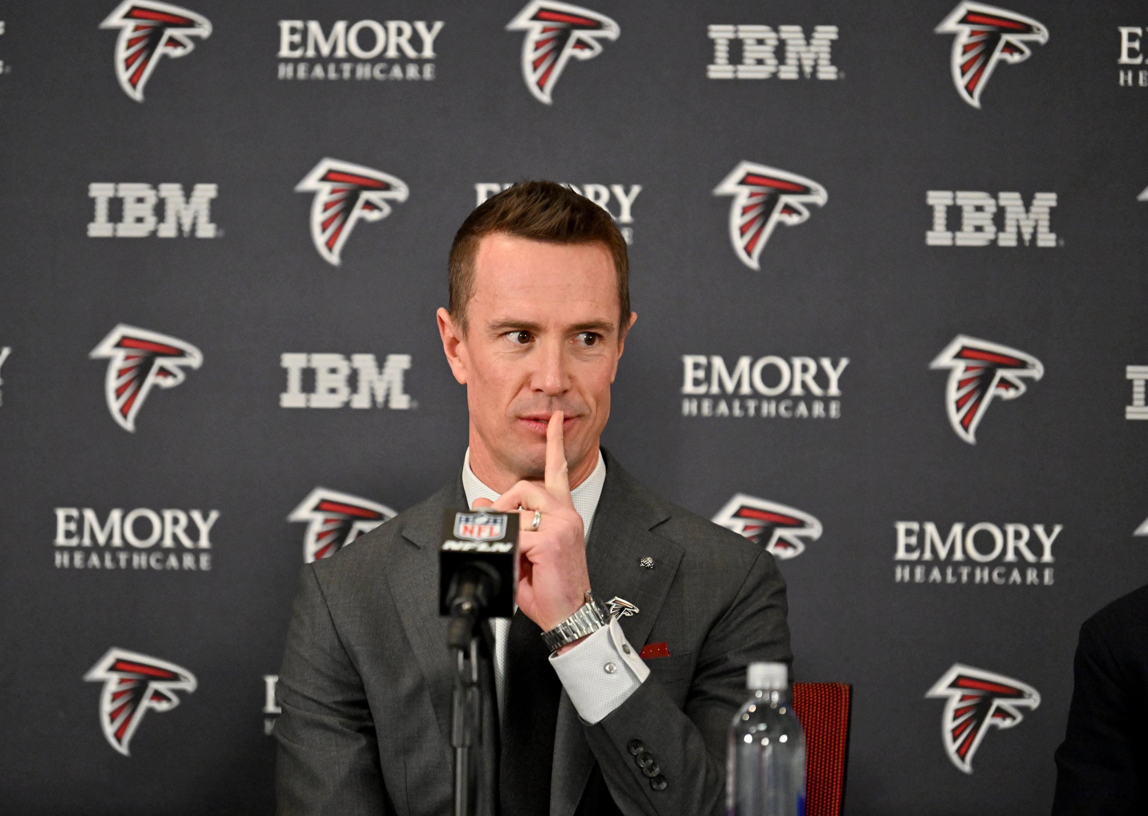 New Falcons president of football Matt Ryan gestures to one of his sons as he enters with Arthur M. Blank and CEO Greg Beadles (both not pictured) for a news conference to introduce new Falcons president of football Matt Ryan, Tuesday, Jan. 13, 2026, in Flowery Branch. (Hyosub Shin/AJC)