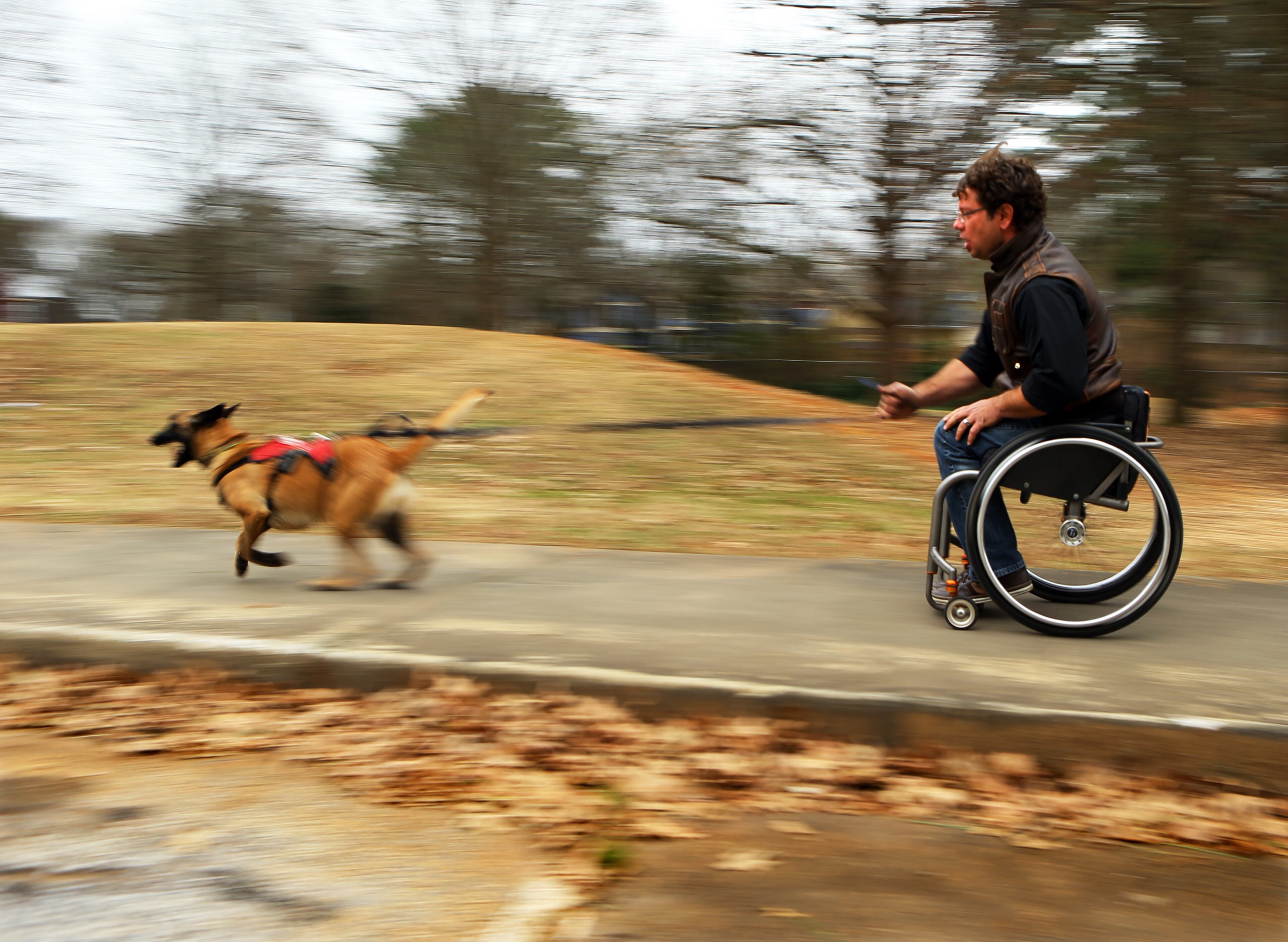 Wheelchair racer Pete Anziano and his dog Amelie both enjoy the thrill of speed during a training session on Thursday, Jan. 9, 2014, in Decatur. Click here to read more about Anziano, his dogs and his sport.
