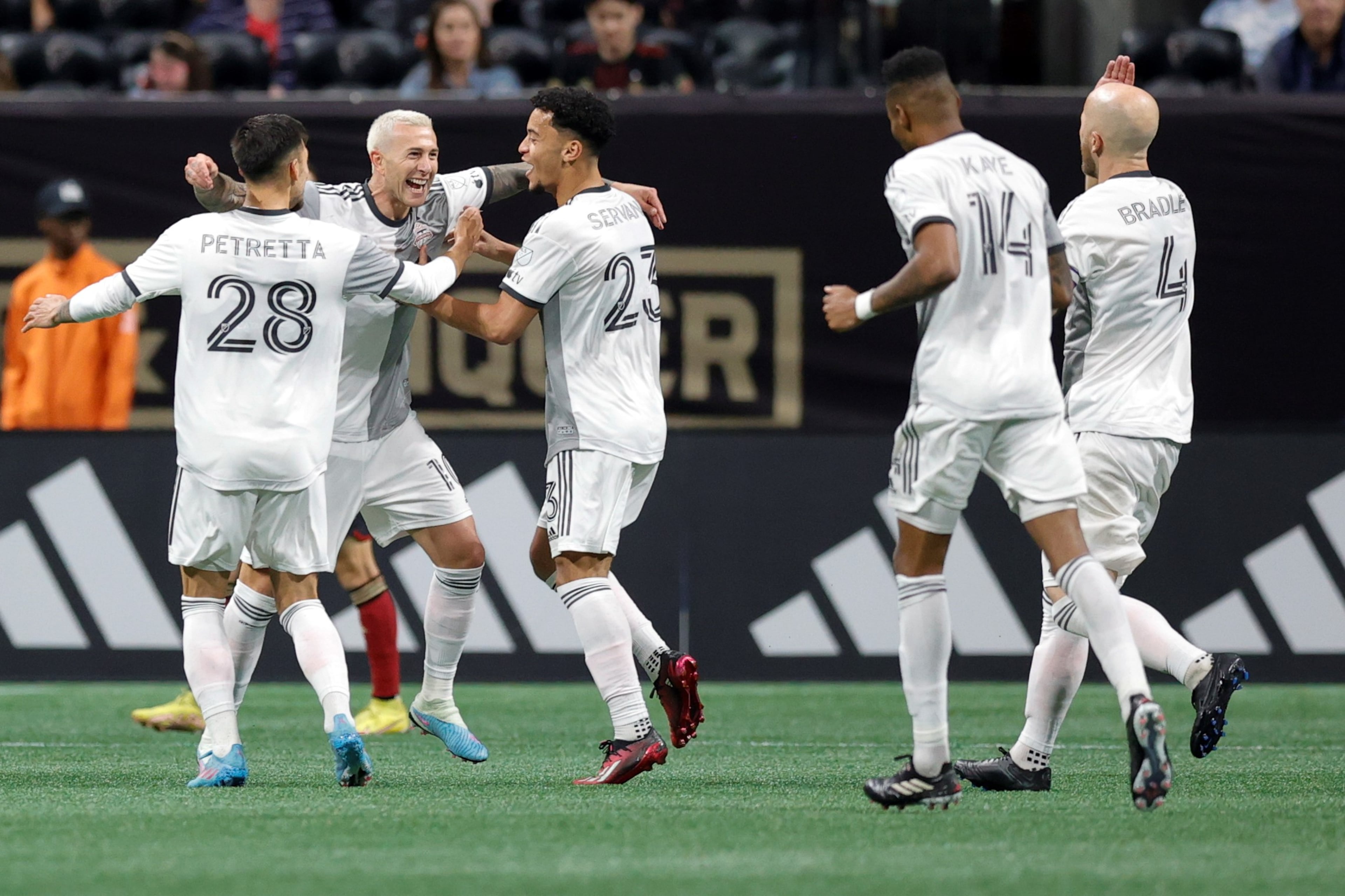 Toronto FC forward Federico Bernardeschi (second from left) celebrates a goal with teammates Raoul Petretta (left) and Brandon Servania during the second half of an MLS soccer match against Atlanta United, Saturday, March 4, 2023, in Atlanta.