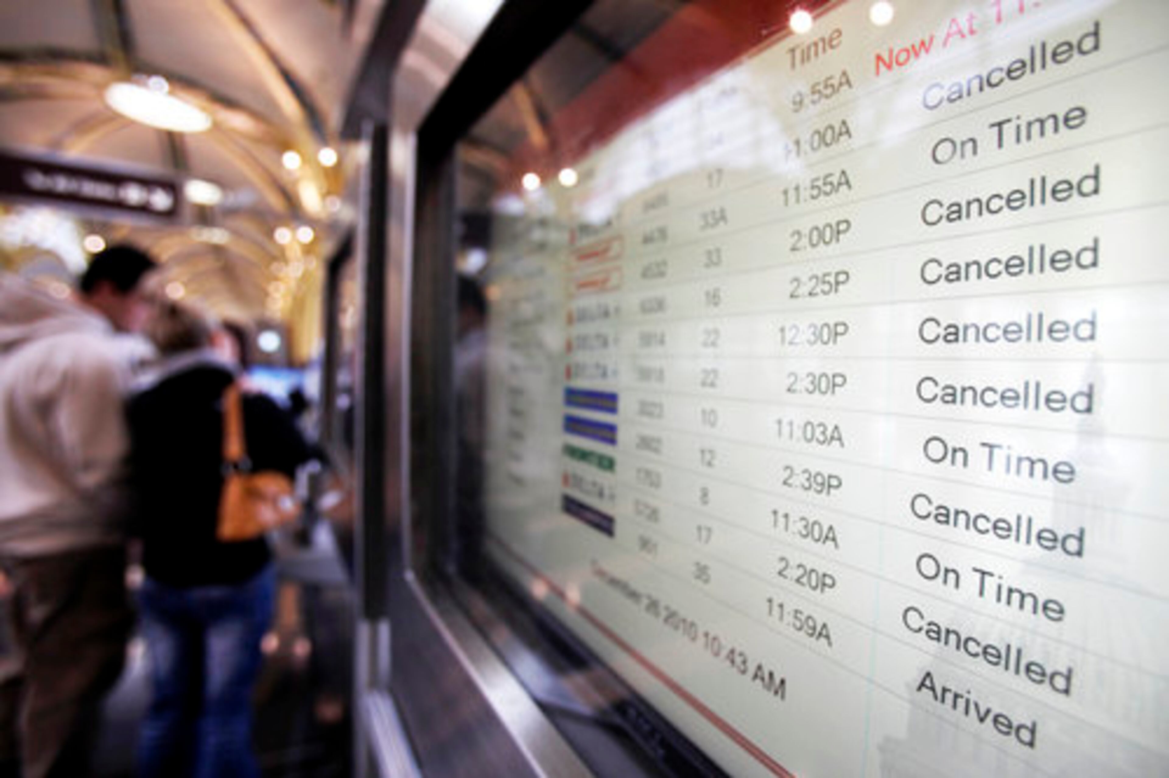 Canceled flights are displayed on a monitor at Reagan National Airport in Arlington, Va., as a winter storm heads up the East coast on Sunday, Dec. 26, 2010.