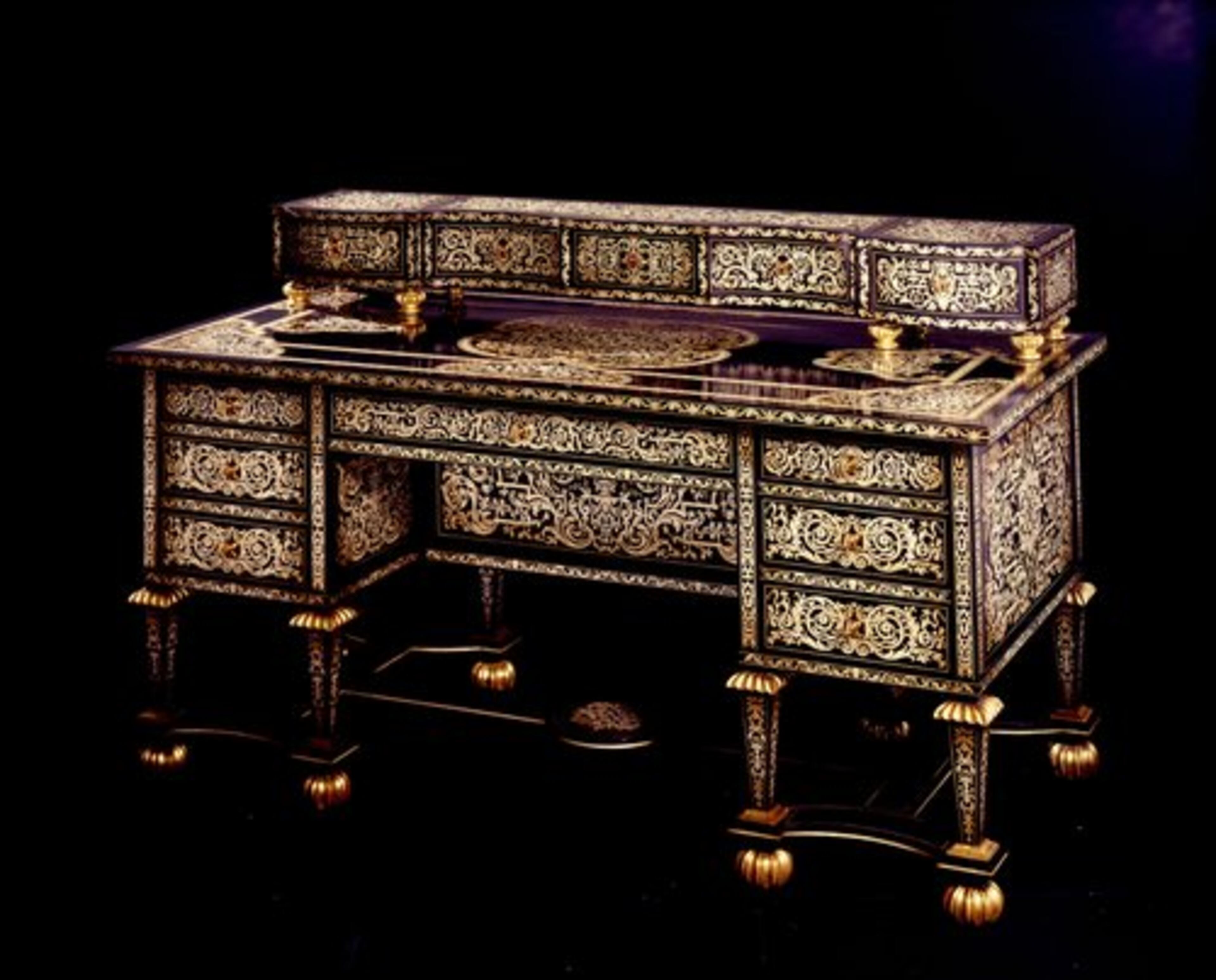The "Il '600" desk is a parcel gilt, ebonized wood writing desk with mother of pearl and precious wood inlay, and French gold bathed brass elements, finished with an antiqued patina finish. It was designed by Maurizio Chiari and handmade in Italy. It retails for more than $190,000.