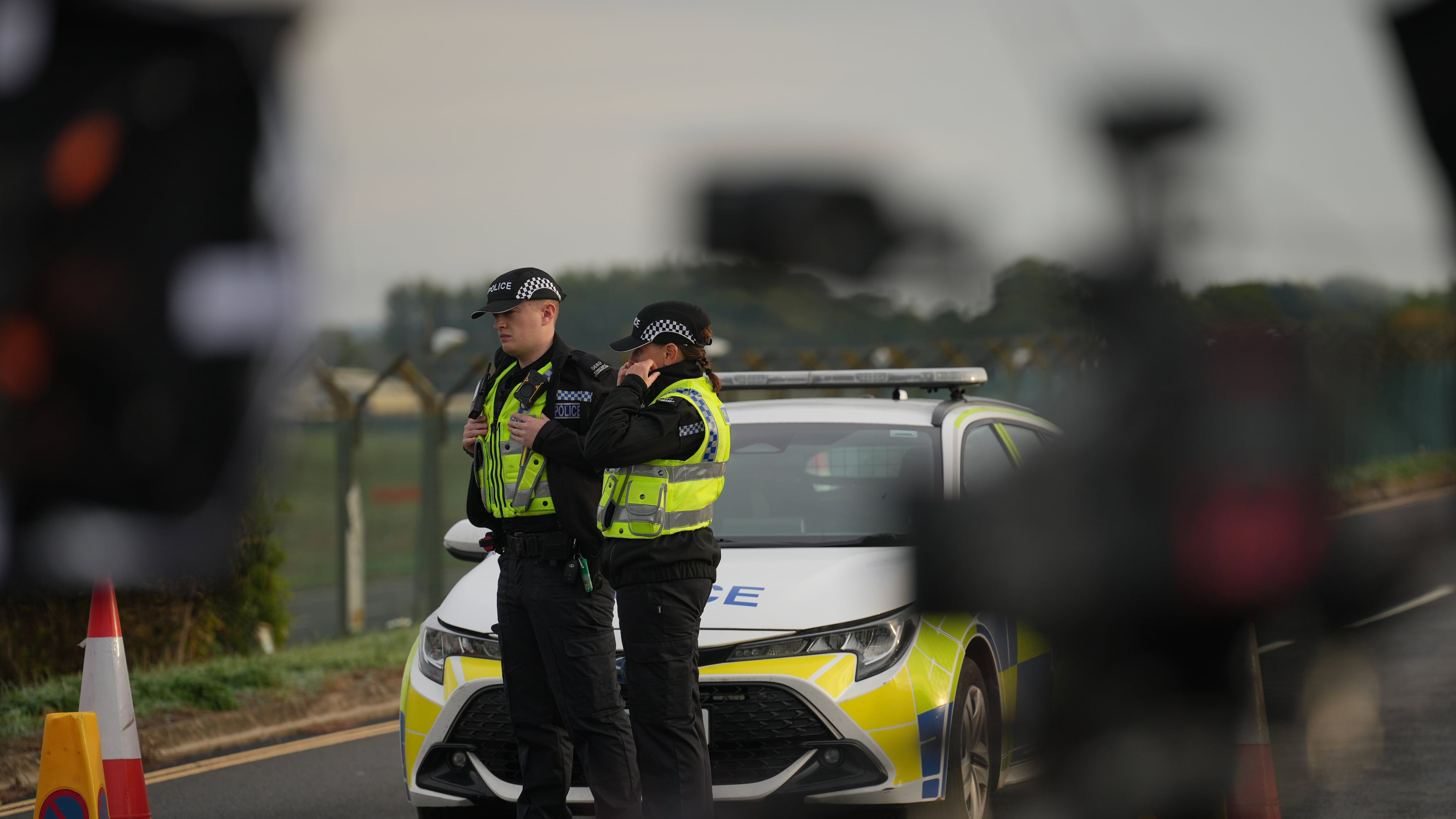 Police officers guard a road leading to RAF Fairford, after an incident in Fairford, England, Monday Sept. 28, 2026. (AP Photo/Alastair Grant)