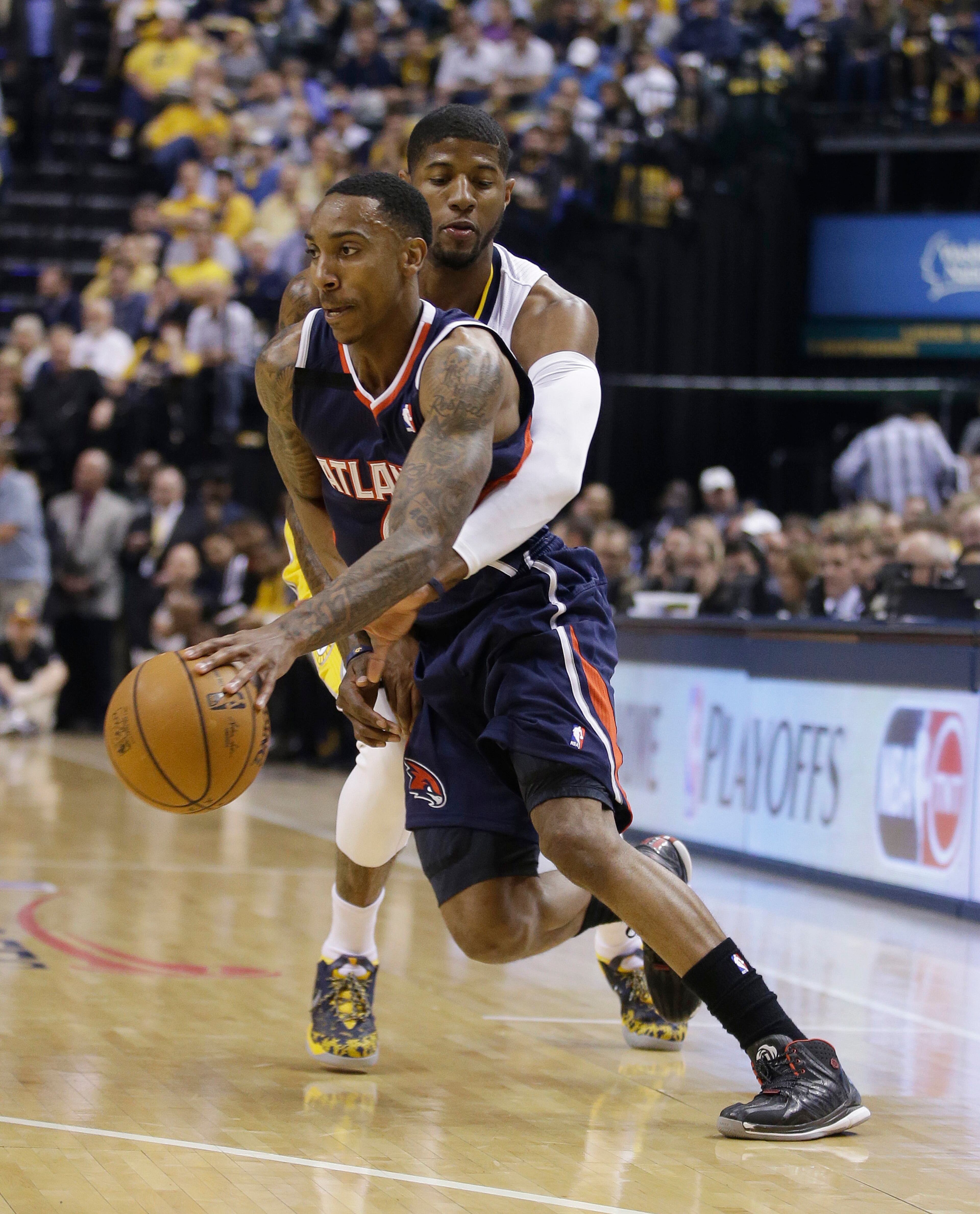 Atlanta Hawks' Jeff Teague is defended by Indiana Pacers' Paul George during the first half in Game 2 of an opening-round NBA basketball playoff series Tuesday, April 22, 2014, in Indianapolis. (AP Photo/Darron Cummings)