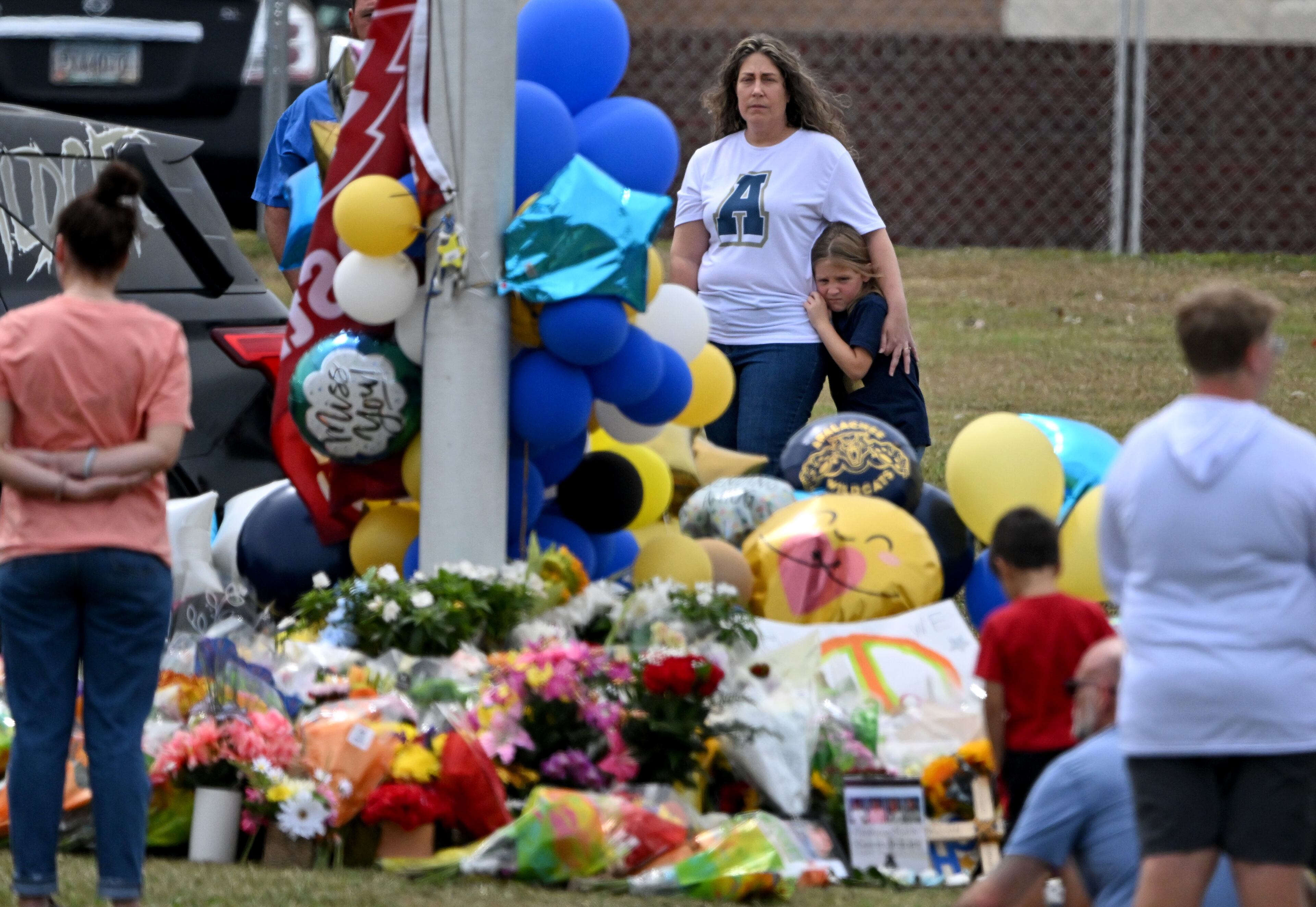 Mourners visit a makeshift memorial at the flagpole at Apalachee High School, Friday, September 6, 2024, in Winder. The 14-year-old Colt Gray accused of fatally shooting two teachers and two students this week at Apalachee High School and his father made their first appearances in court Friday. (Hyosub Shin / AJC)