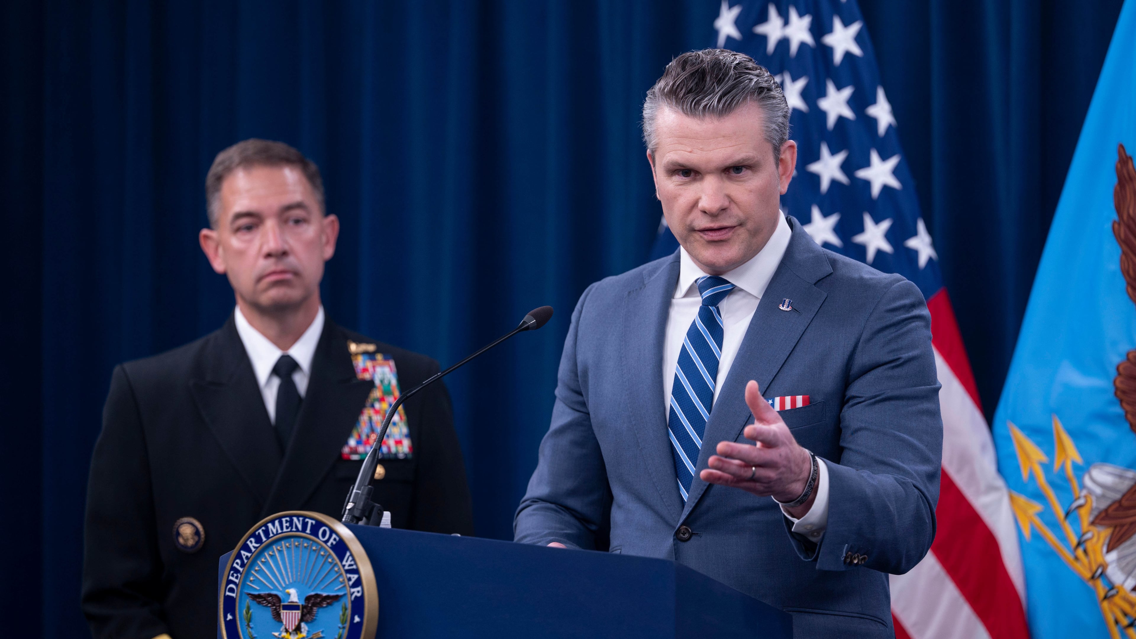 Defense Secretary Pete Hegseth is joined by Adm. Brad Cooper, left, as he speaks to members of the media during a press briefing at the Pentagon, Thursday, April 16, 2026 in Washington. (AP Photo/Kevin Wolf)