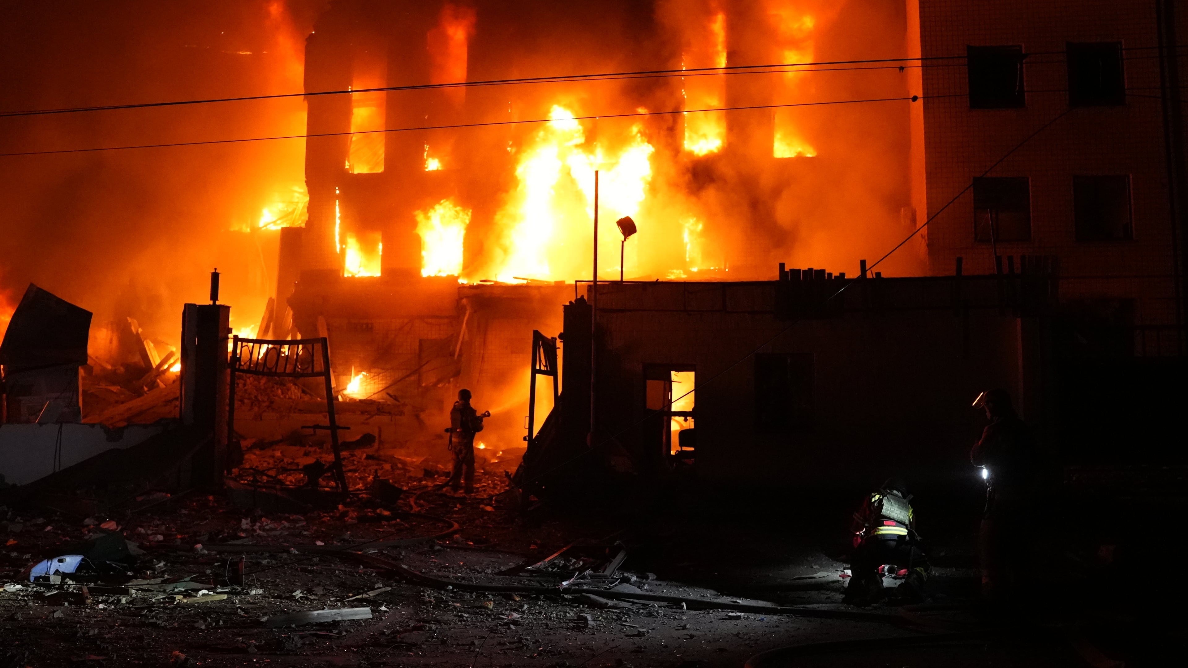 A rescue worker puts out a fire of a building destroyed after a Russian missile attack in Kyiv, Ukraine Tuesday, Sept. 8, 2026. (AP Photo/Alex Babenko)