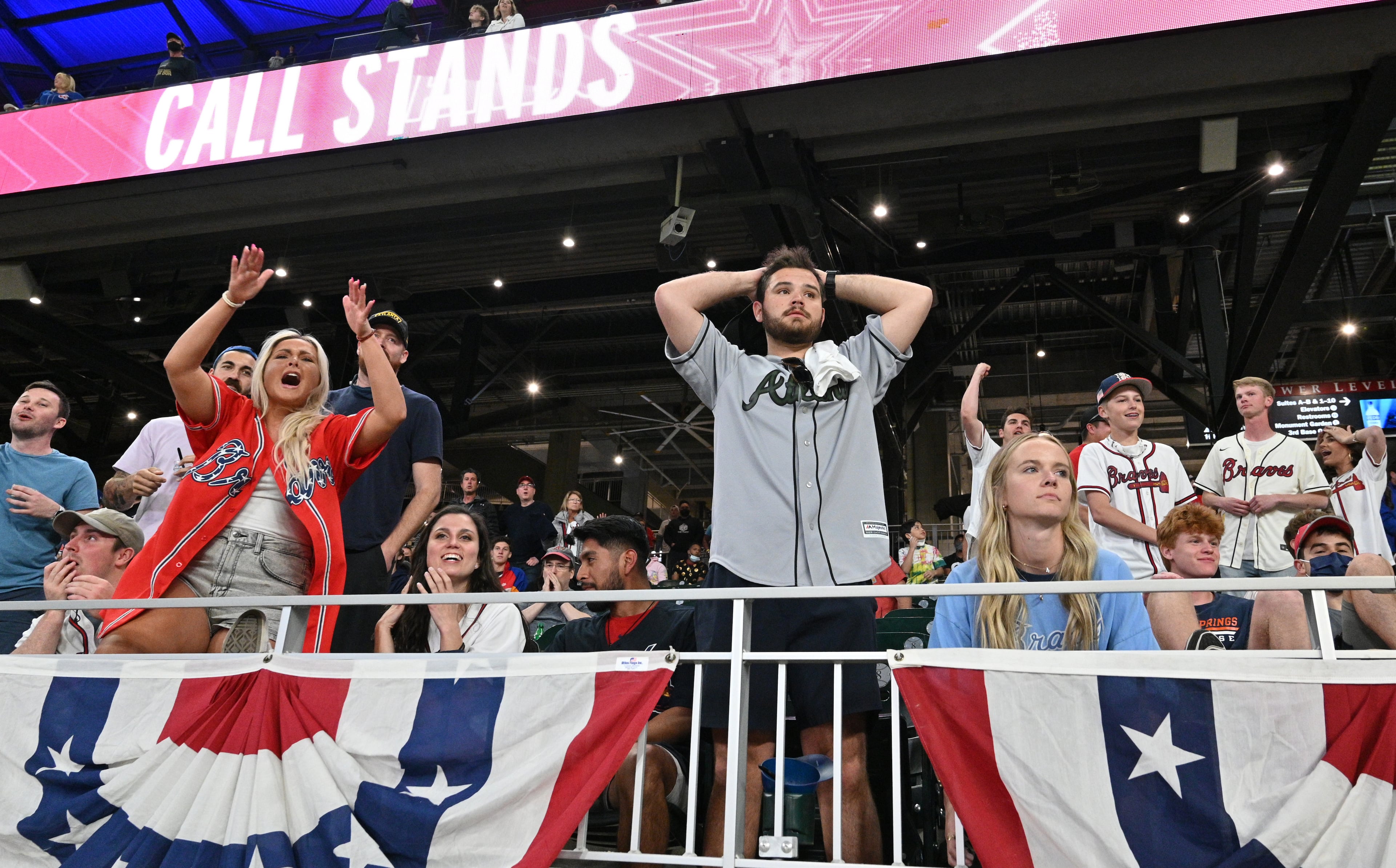Braves fans react after a call by Atlanta disputing a ninth inning run scored by the Philadelphia Phillies is upheld Sunday, April 11, 2021, at Truist Park in Atlanta. The Phillies won 7-6. (Hyosub Shin / Hyosub.Shin@ajc.com)