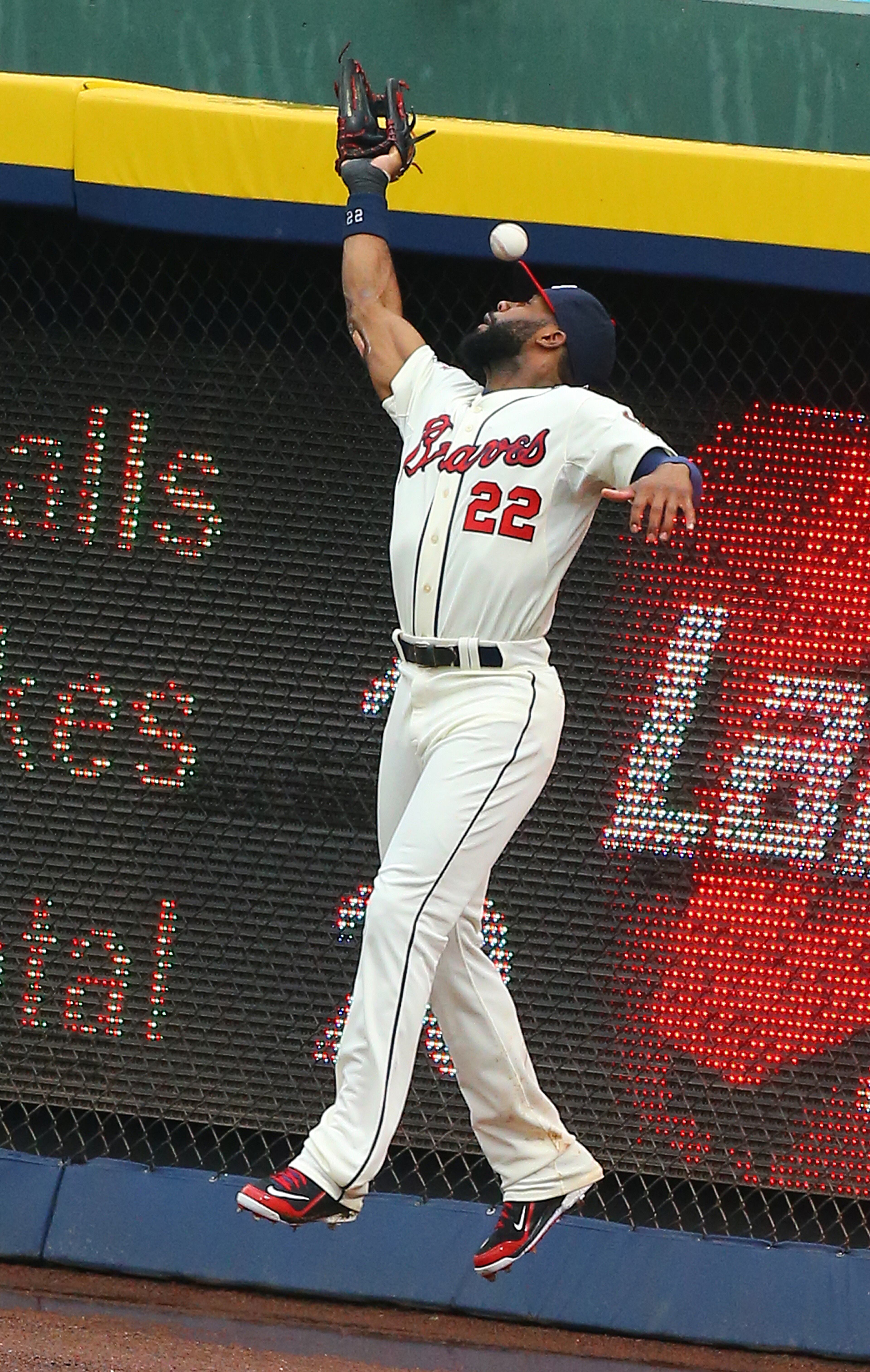 Braves Jason Heyward just misses a single by Phillies Grady Sizemore at the wall during the eight inning of an MLB game on Sunday, July 20, 2014, in Atlanta. CURTIS COMPTON / CCOMPTON@AJC.COM