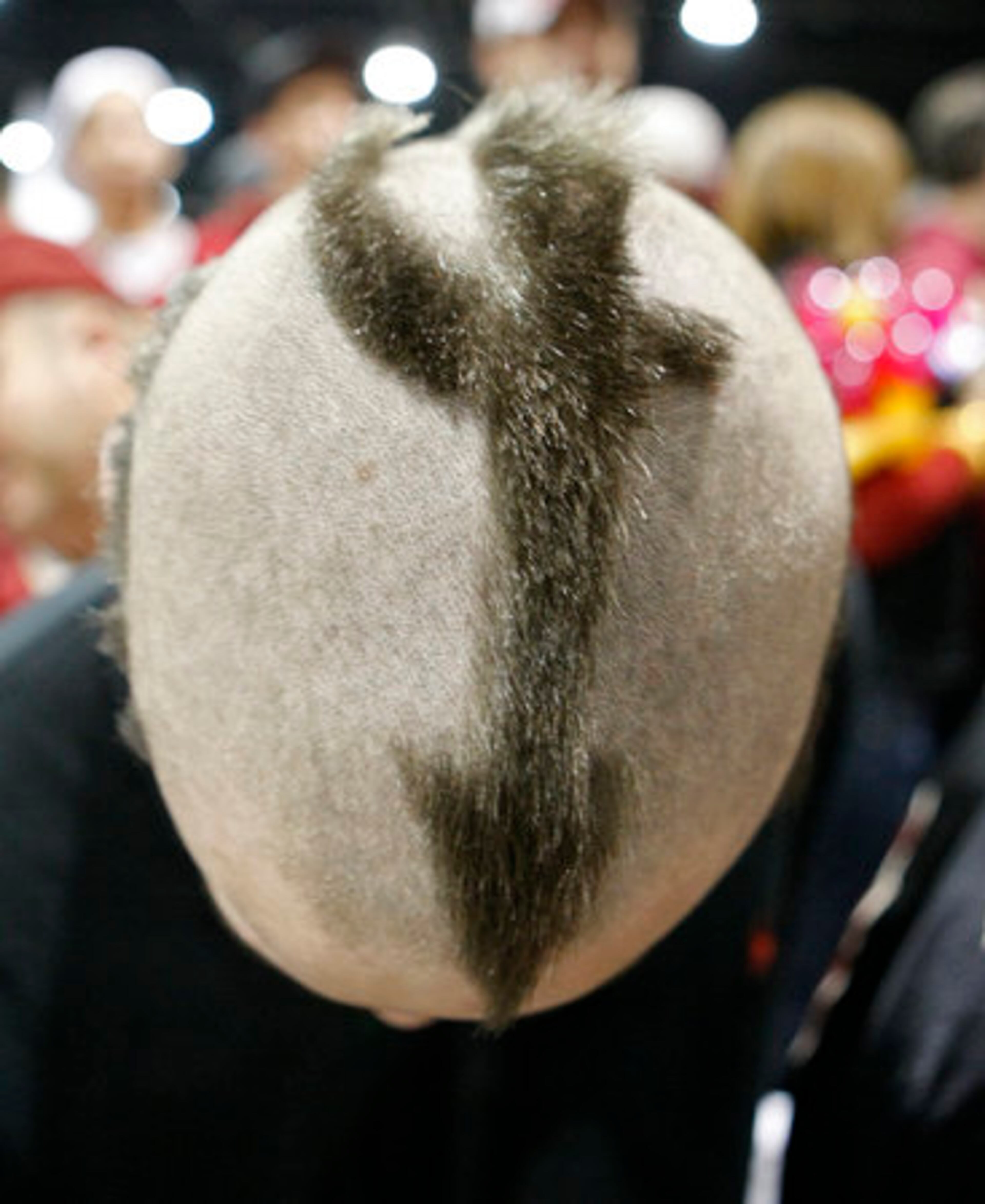 Florida State Seminoles fan Wayne Cinard shaved his head to display his team spirit during the Seminoles team walk to the Georgia Dome for the Chick-fil-A Bowl and a ACC vs SEC match up on Friday, Dec. 31, 2010.