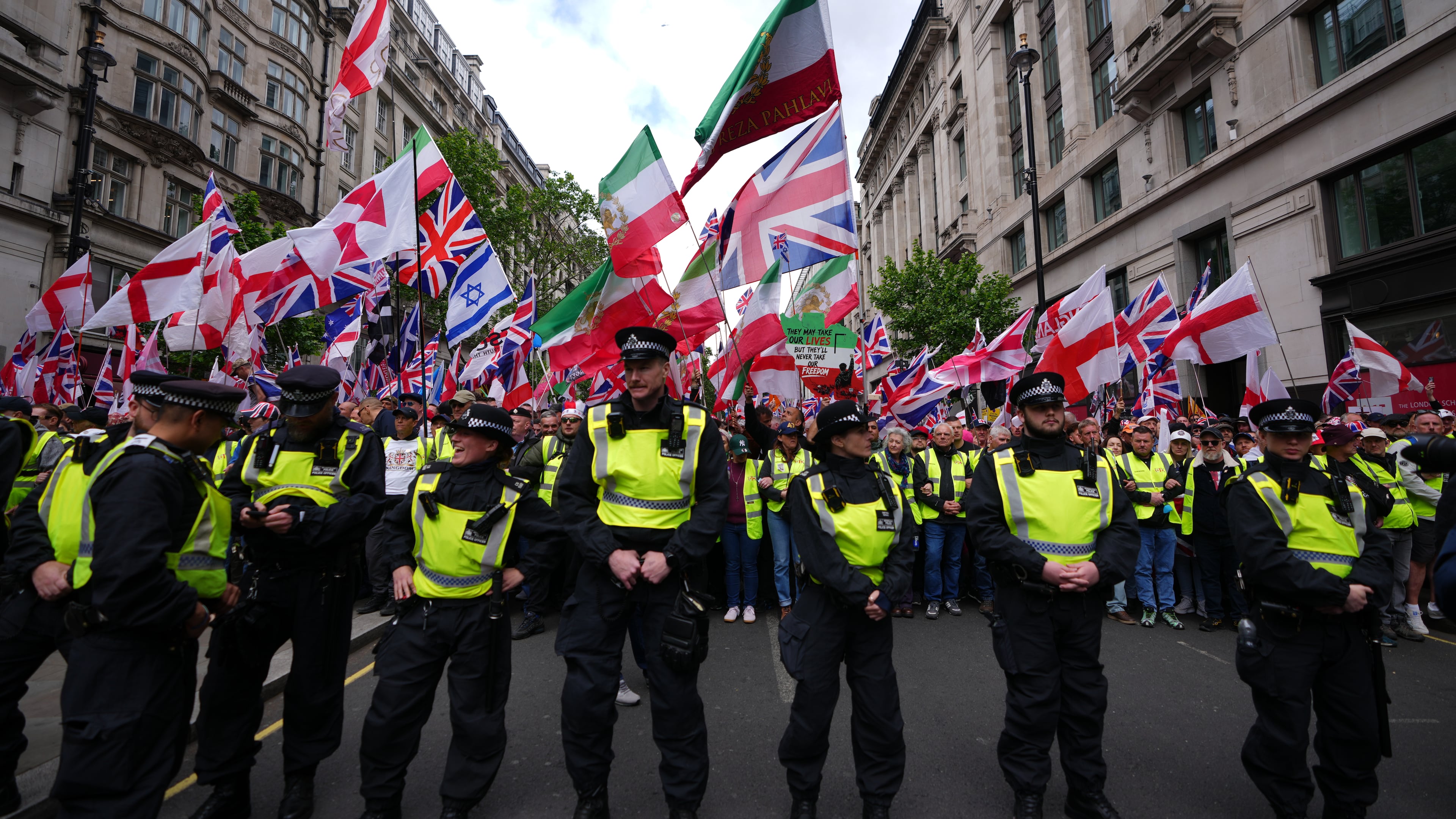 Police forces stand in front of the far right Unite the Kingdom march in London, Saturday, May 16, 2026.(AP Photo/Kirsty Wigglesworth)