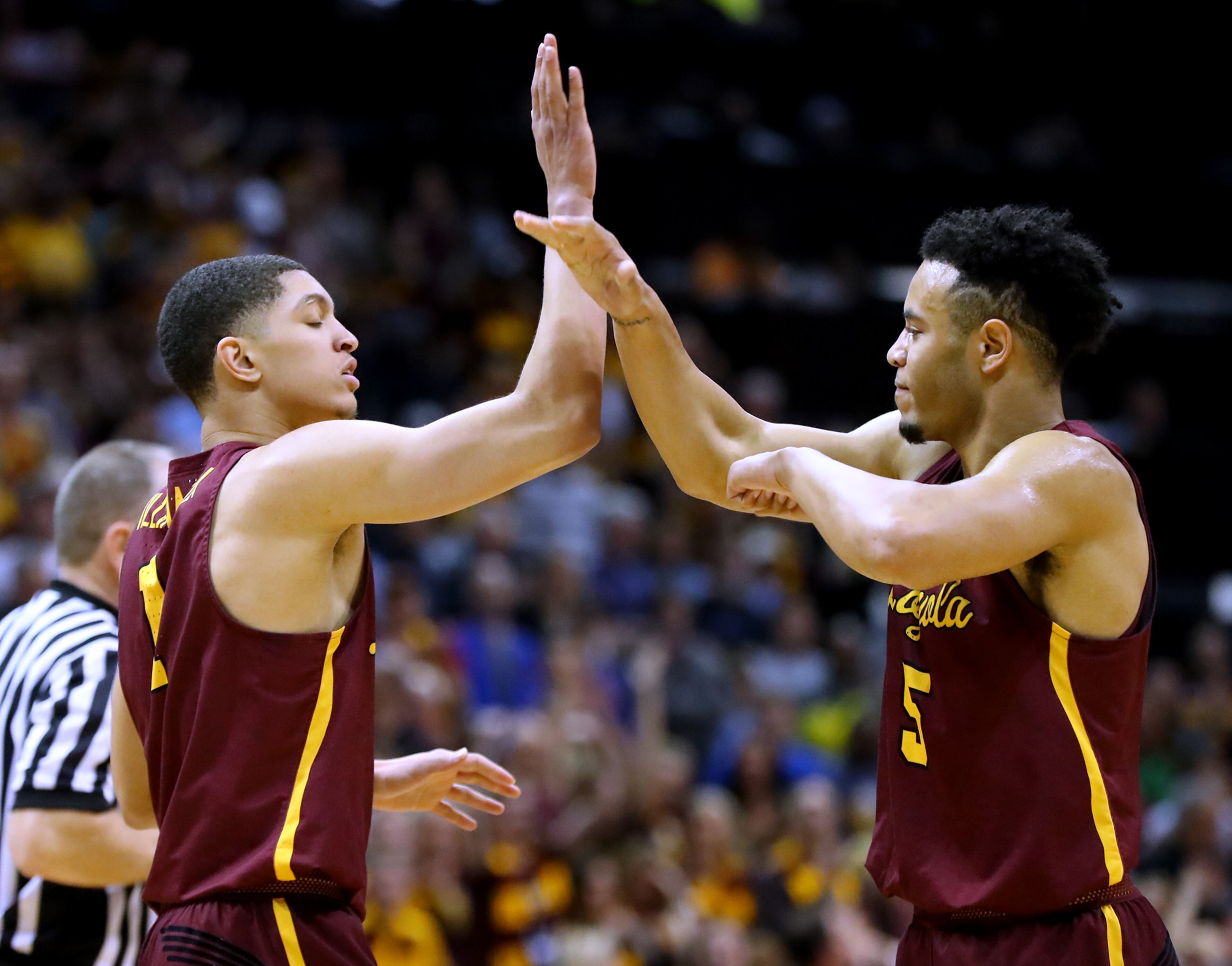 March 24, 2018 Atlanta: Loyola guard Lucas Williamson (left) gets five from Marques Townes after sinking a basket and drawing a foul against Kansas State during the first half in a regional final NCAA college basketball game on Saturday, March 24, 2018, in Atlanta. Curtis Compton/ccompton@ajc.com
