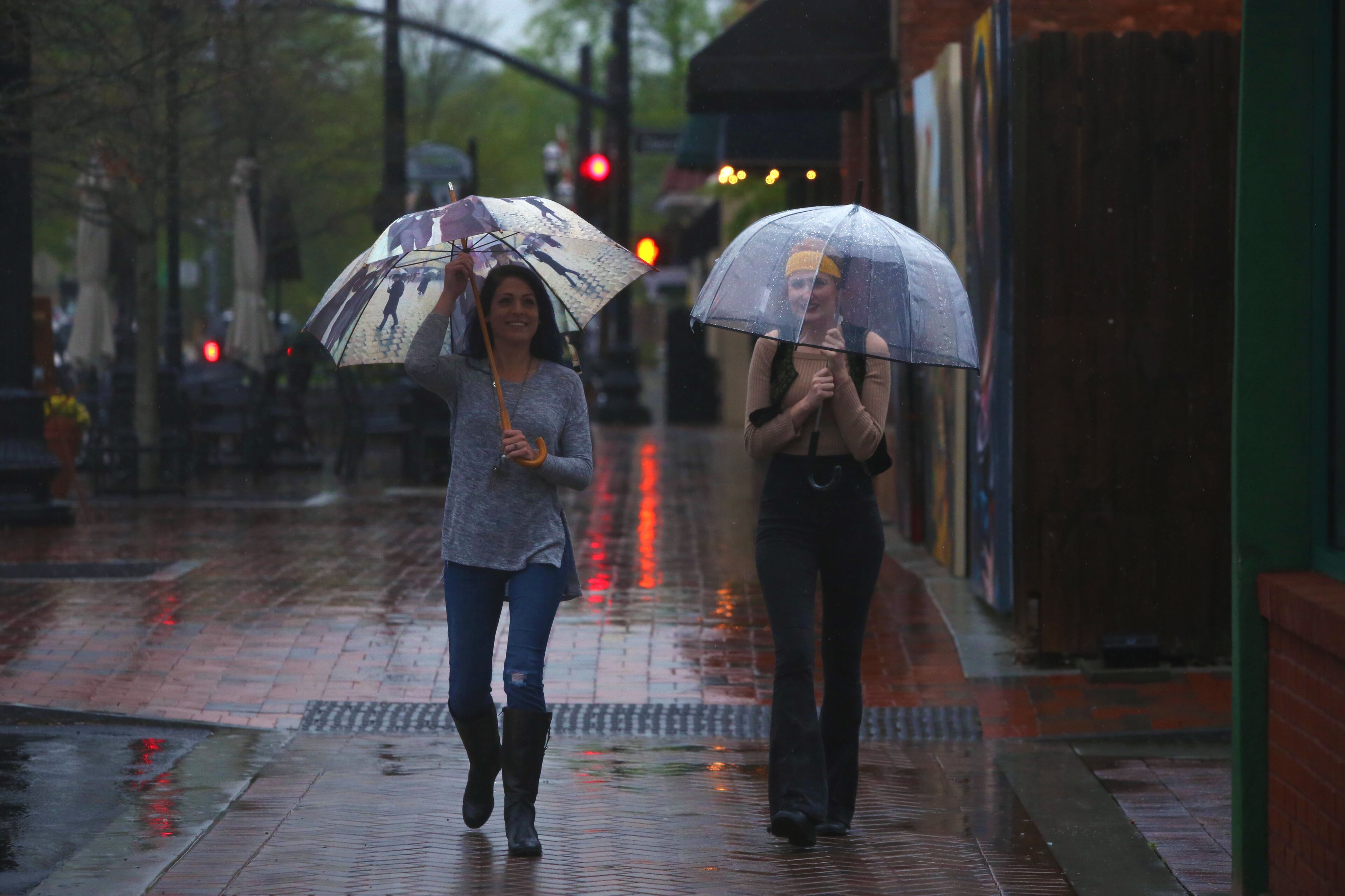 April 5, 2017, Atlanta, Georgia - People walk down the streets of the square downtown with umbrellas unsheathed in Marietta, Georgia, on April 5, 2017. (HENRY TAYLOR / HENRY.TAYLOR@AJC.COM)