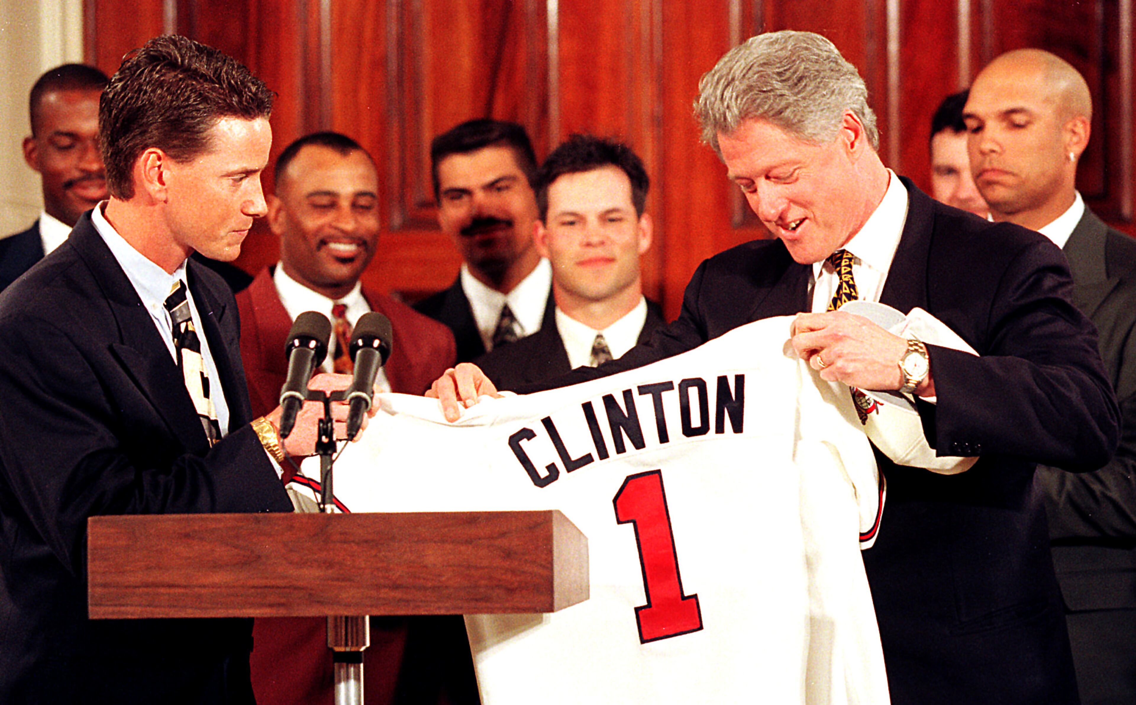 President Clinton accepts an Atlanta Braves shirt from Glavine during a White House ceremony Monday honoring the 1995 World Series champions.