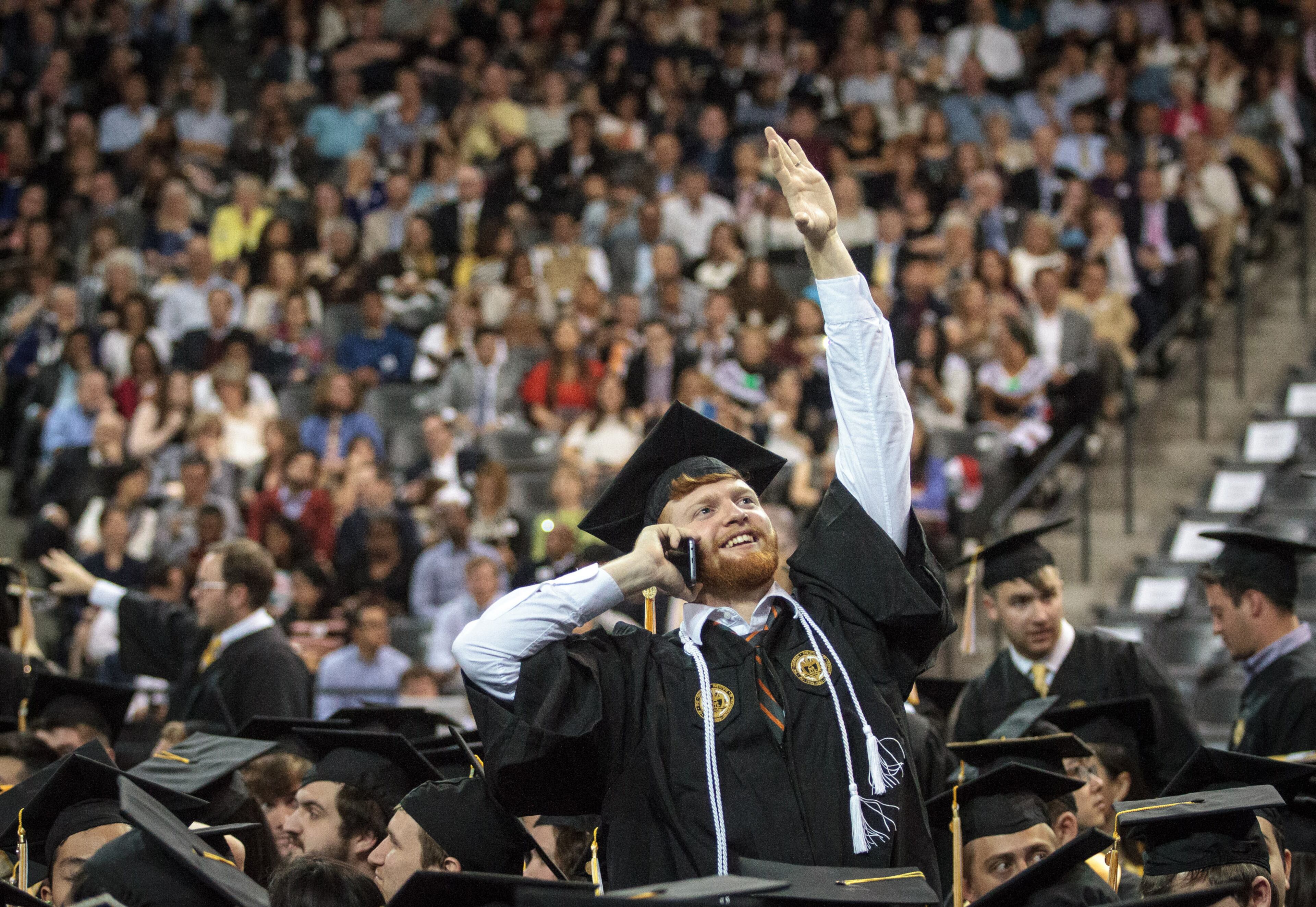 A Georgia Institute of Technology student waves to friends and family before the start of the morning graduation ceremony at McCamish Pavilion, May. 6 2017. 2,400 students graduated during the two ceremonies Saturday. STEVE SCHAEFER / SPECIAL TO THE AJC