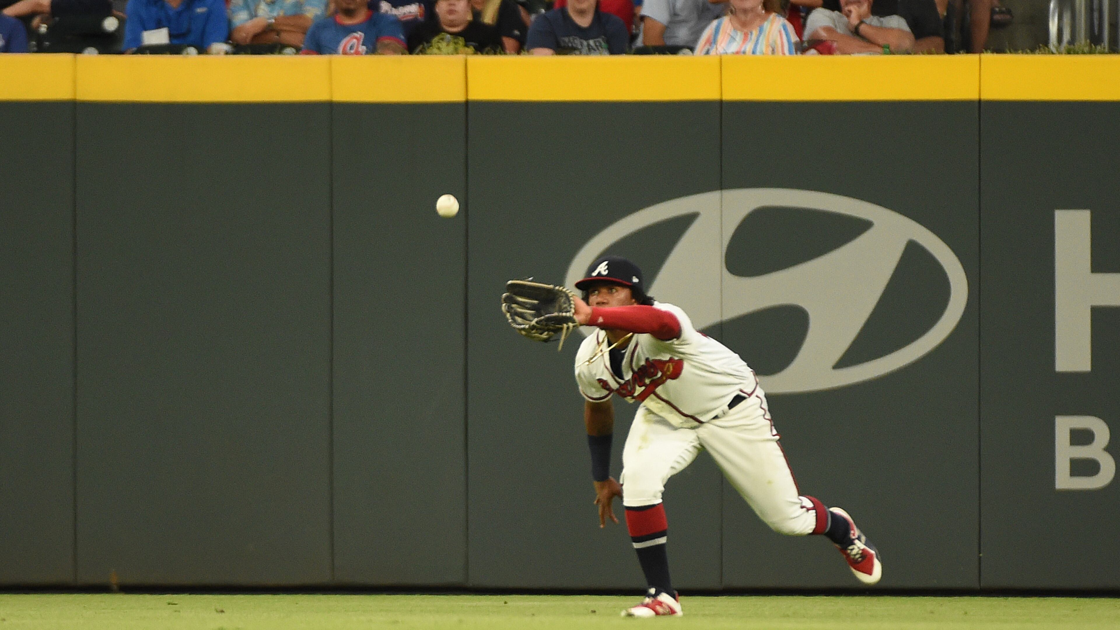 Braves' Ronald Acuna fields a ball in the fourth inning against the Los Angeles Dodgers Saturday,, Aug. 17, 2019, at SunTrust Park in Atlanta.