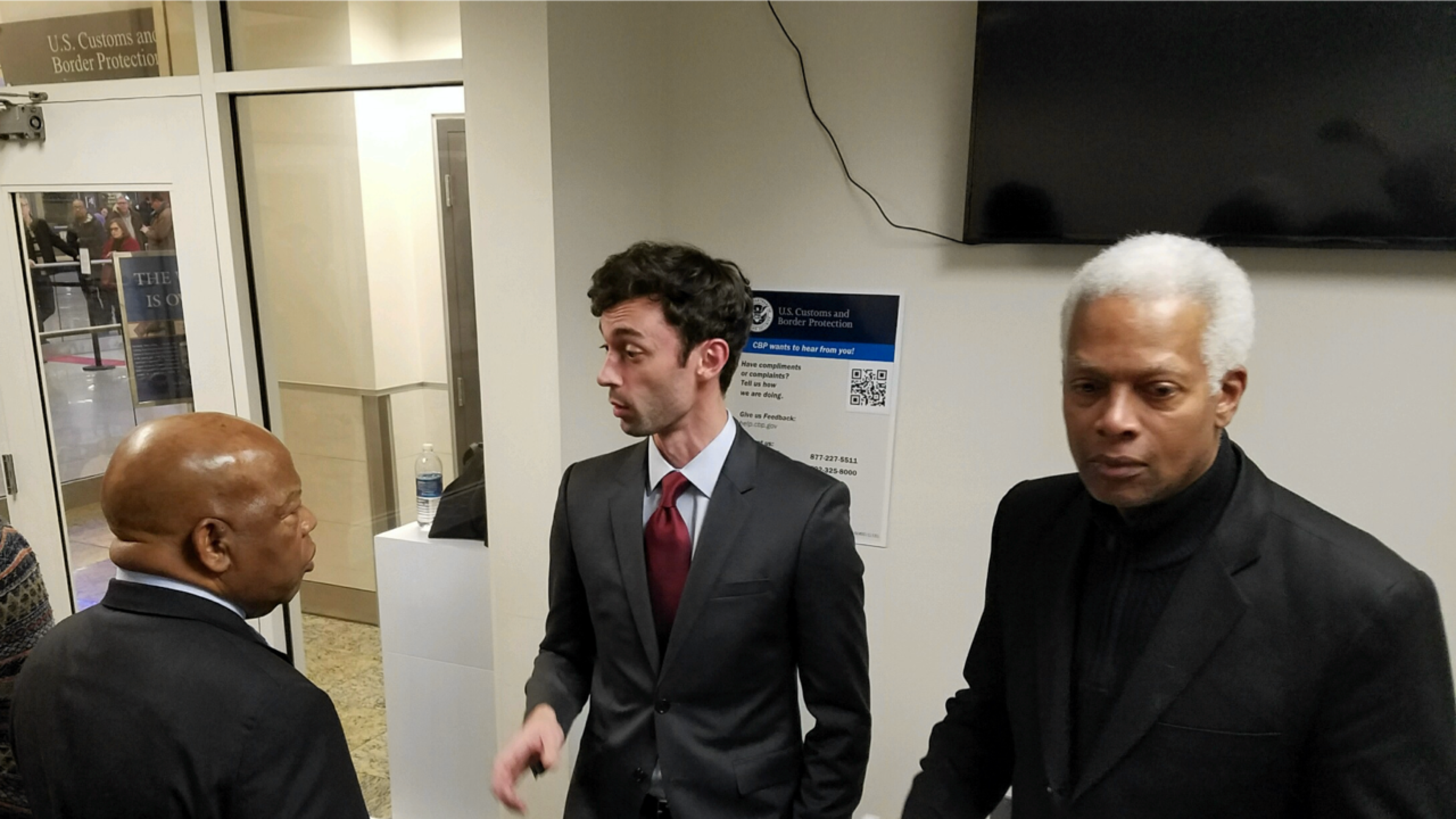 Jon Ossoff, center, is flanked by Georgia Reps. John Lewis and Hank Johnson at Atlanta's airport.
