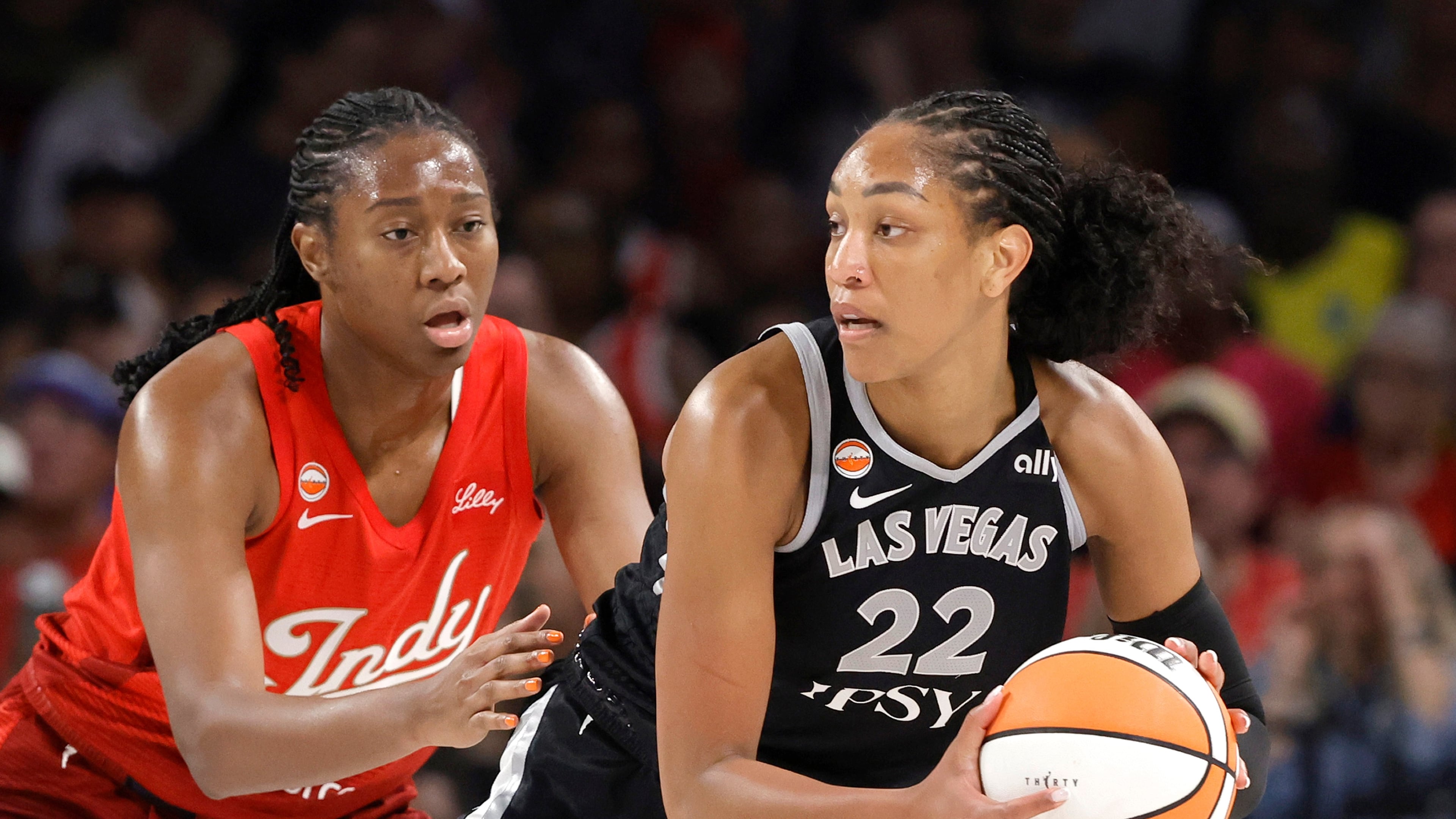 Indiana Fever center-forward Aliyah Boston, left, defends against Las Vegas Aces center A'ja Wilson (22) during the first half of an WNBA basketball game Sunday, July 12, 2026, in Las Vegas. (Steve Marcus/Las Vegas Sun via AP)