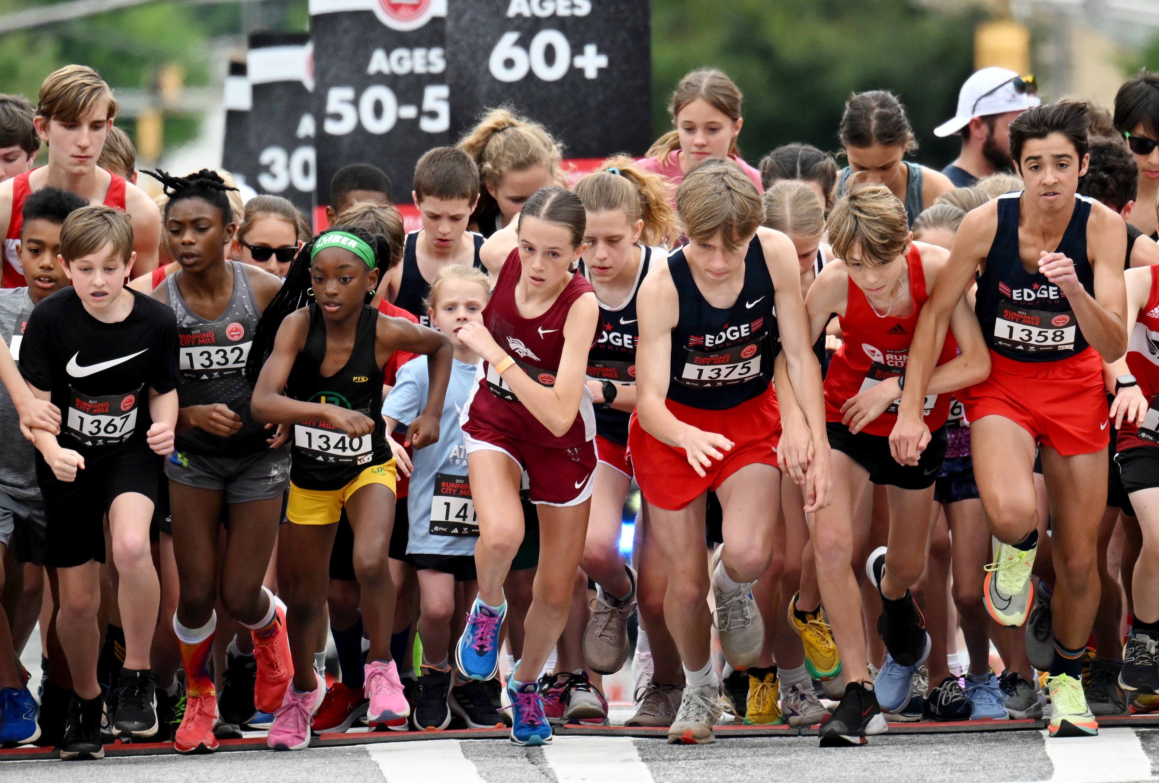 Runners 14 years old and under start the Running City mile during the inaugural adidas Atlanta City Games at Centennial Olympic Park, Saturday, May 6, 2023, in Atlanta. (Hyosub Shin / Hyosub.Shin@ajc.com)