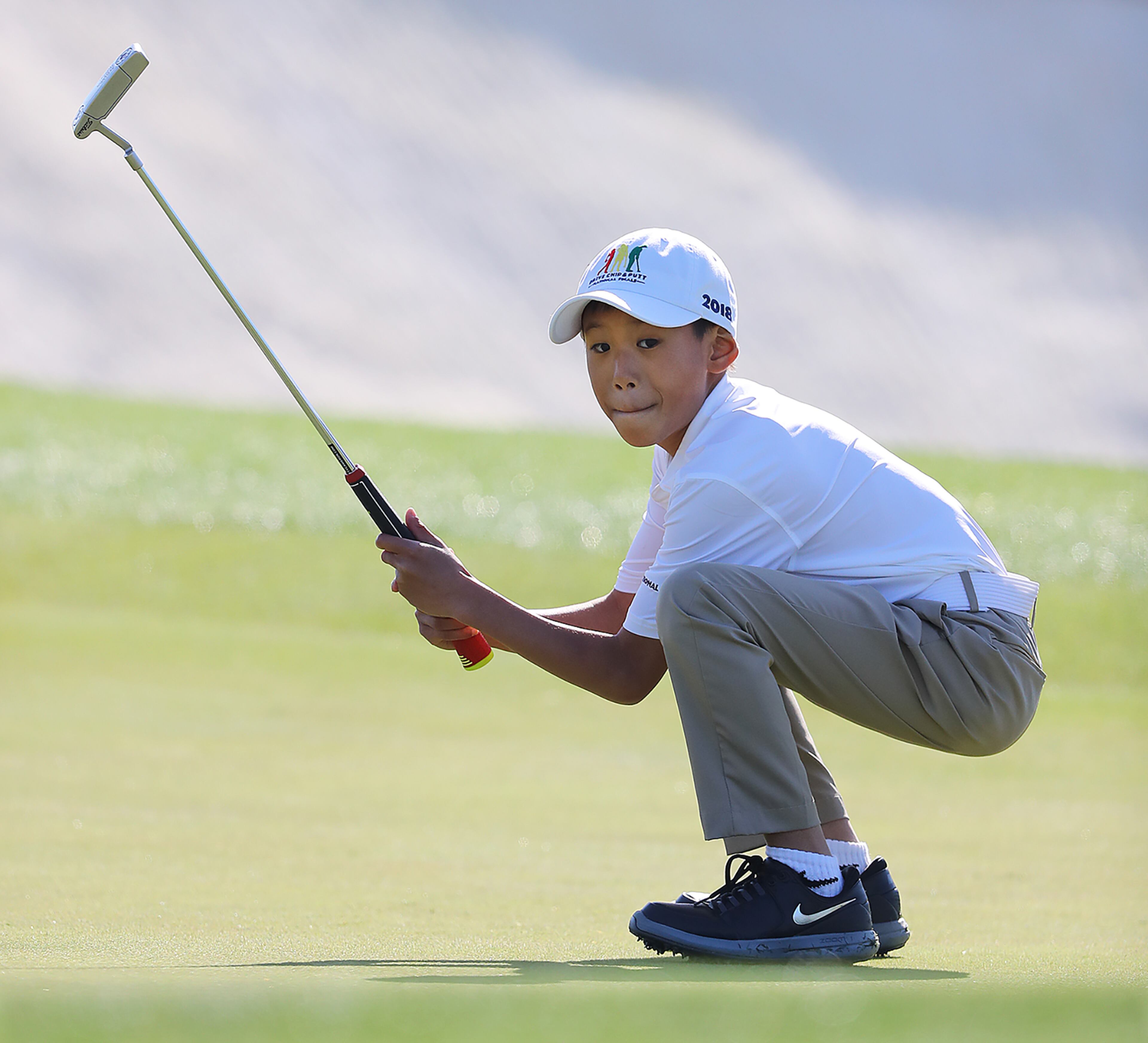 April 1, 2018 Atlanta: Taighan Chea, Bothell, WA, reacts to sinking his putt on the 18th green during the Drive Chip & Putt National Finals at Augusta National Golf Club on Sunday, April 1, 2018, in Augusta. The putt gave Chea the 7-9 year old boys putting title and the overall championship for his age group. Curtis Compton/ccompton@ajc.com