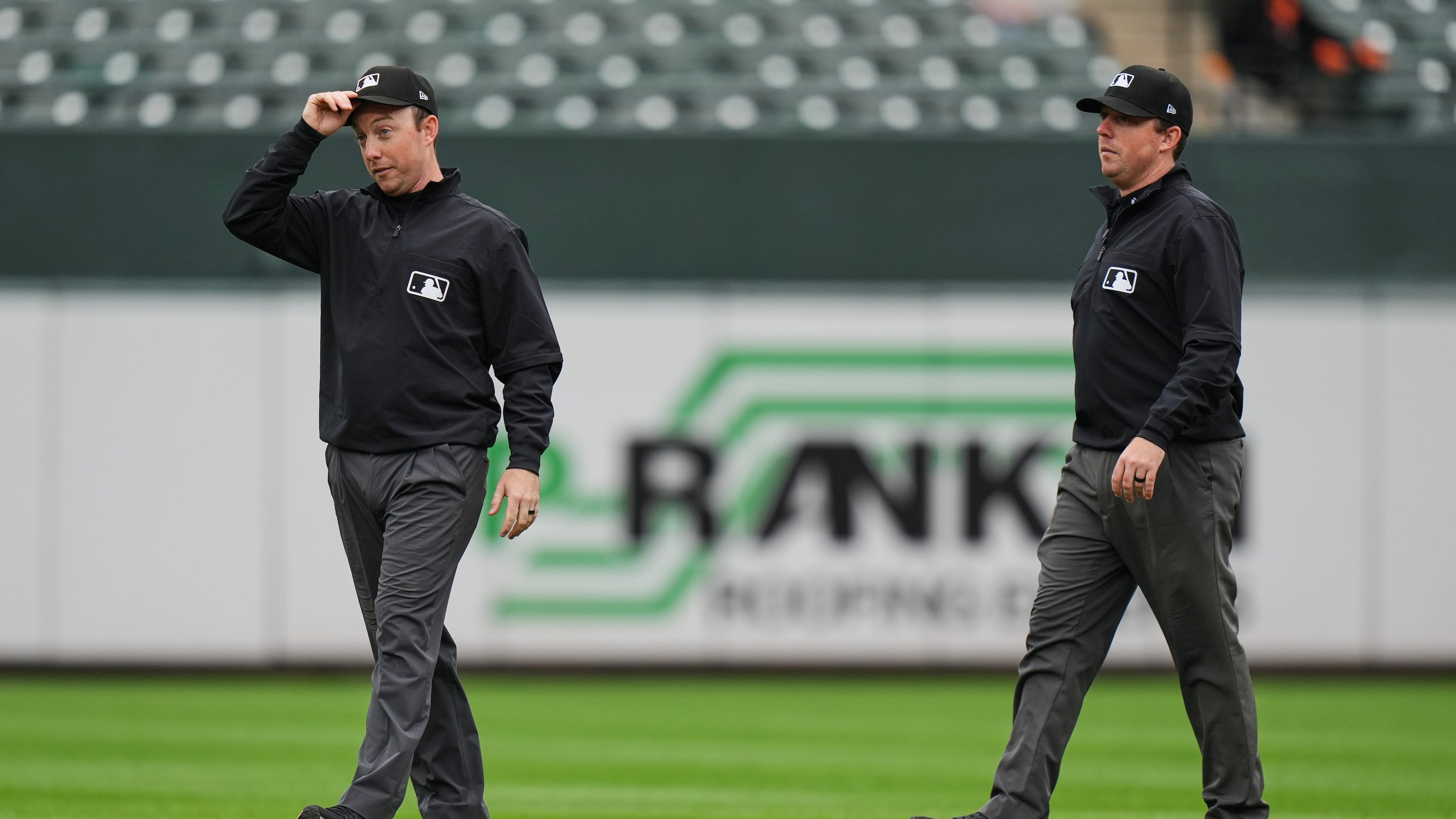 Second base umpire Tyler Jones, left, and his twin brother first base umpire Austin Jones walk on the field during the second inning in the first baseball game of a doubleheader between the Baltimore Orioles and the Toronto Blue Jays, Wednesday, Sept. 23, 2026, in Baltimore. (AP Photo/Stephanie Scarbrough)